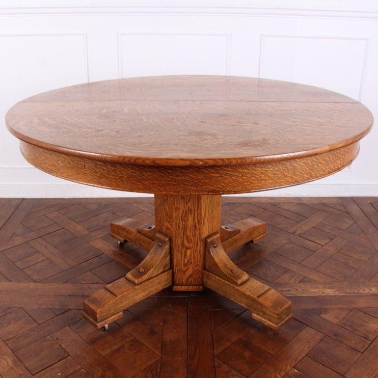 A solid quarter-sawn oak round single pedestal dining table with four solid plank leaves, circa 1910.

Measures: 50? diameter x 30? tall x 4 x 11? leaves = 94