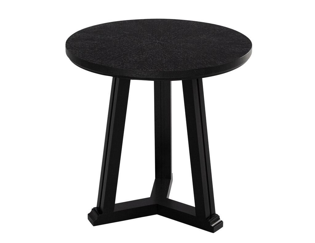 Round oak side table in cerused black finish. Simplistic modern styling with beautiful textured oak top. Featuring a satin black finish with cerused top to bring out the magnificent starburst oak grain pattern. The perfect accent table for any