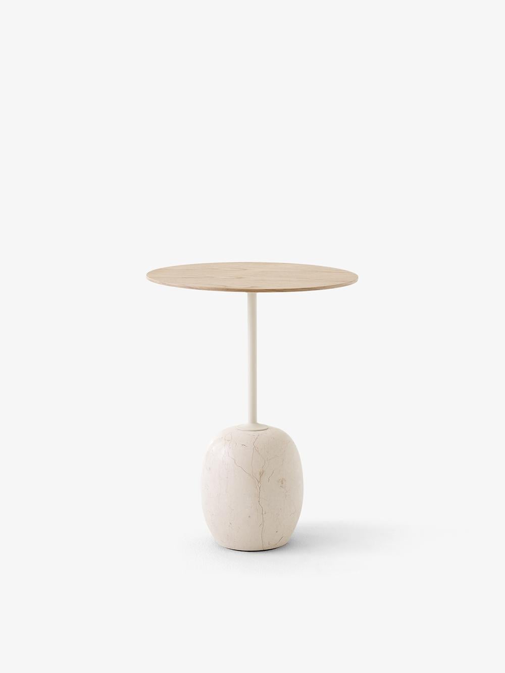 At first glance, Lato resembles a sculpture, with its slim, round table top balanced by an oval-shaped base. 
The marble is turned into shape on a lather and then honed to a semi Matt finish. 
Striking, graphic and poetic, its purity of form is
