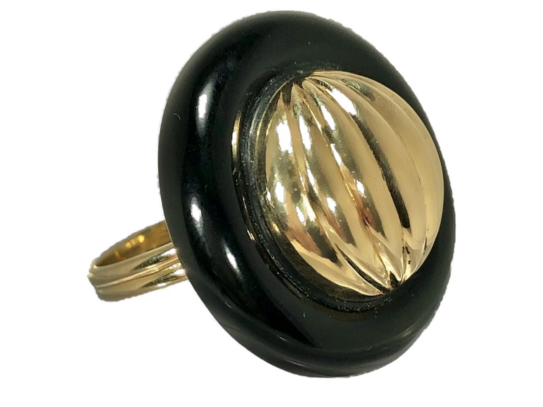 This smart, tailored, onyx ring sports a fluted 14K gold dome center. Lightweight and comfortable to wear, it is a great every day piece. The ring is presently Size 7 and is sizeable.  Diameter is 1 1/16 inch.  Gross weight 11.3 grams.
