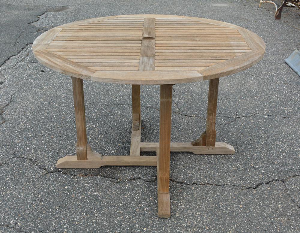 Vintage outdoor teak garden, porch or patio dining table with center hole for umbrella.
Measures: (table) H 29.75
