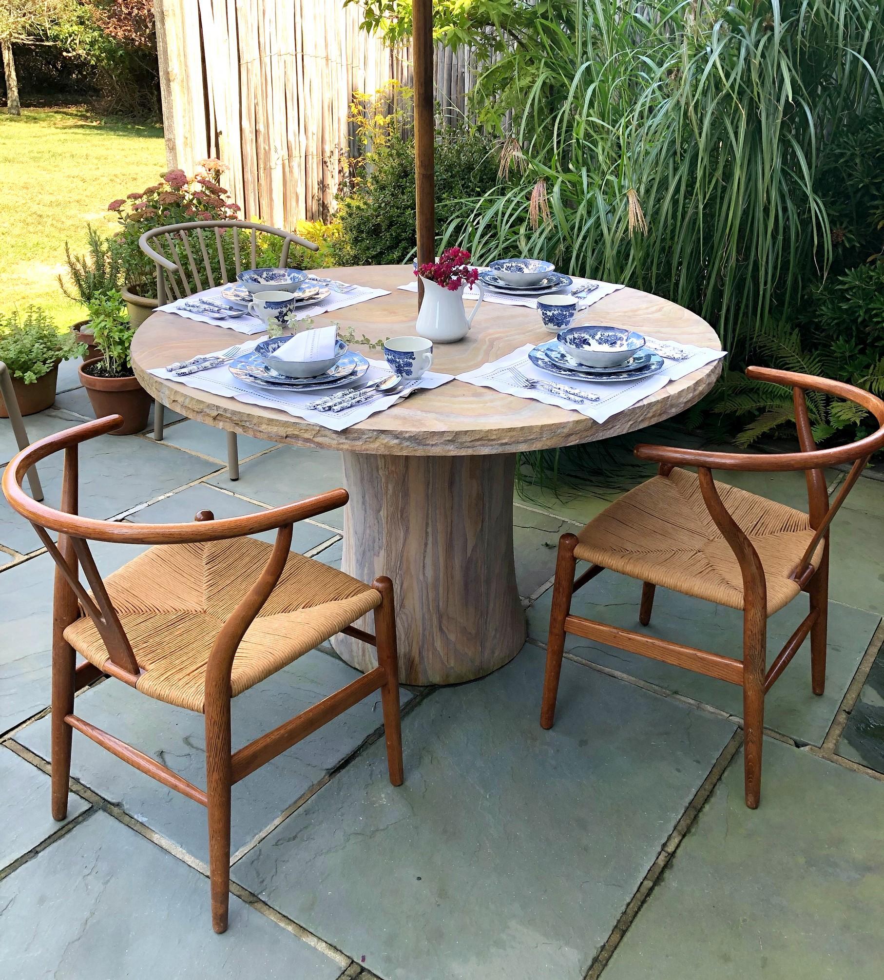 This round outdoor table is designed by Paul Mathieu for Stephanie Odegard. 
This is a hand-carved, hand-crafted round outdoor table. 

When the renowned designer Paul Mathieu first saw the extraordinary swirling colours and patterning of the modern