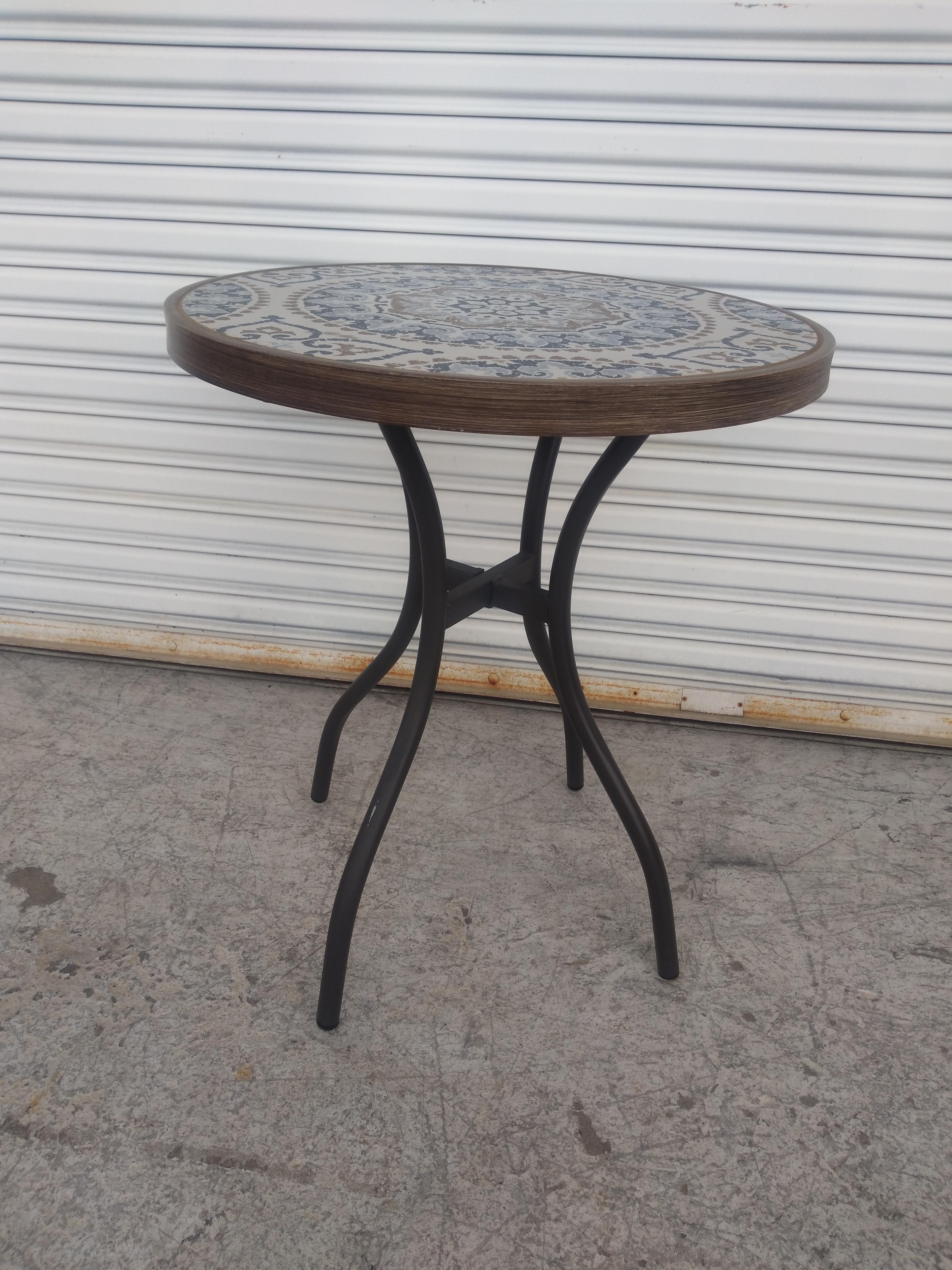 This is a beautiful tile top patio table by Stylewell. The base is made of metal and is pedestal with 4 legs for stability. The top is a beautiful mosaic style tile.