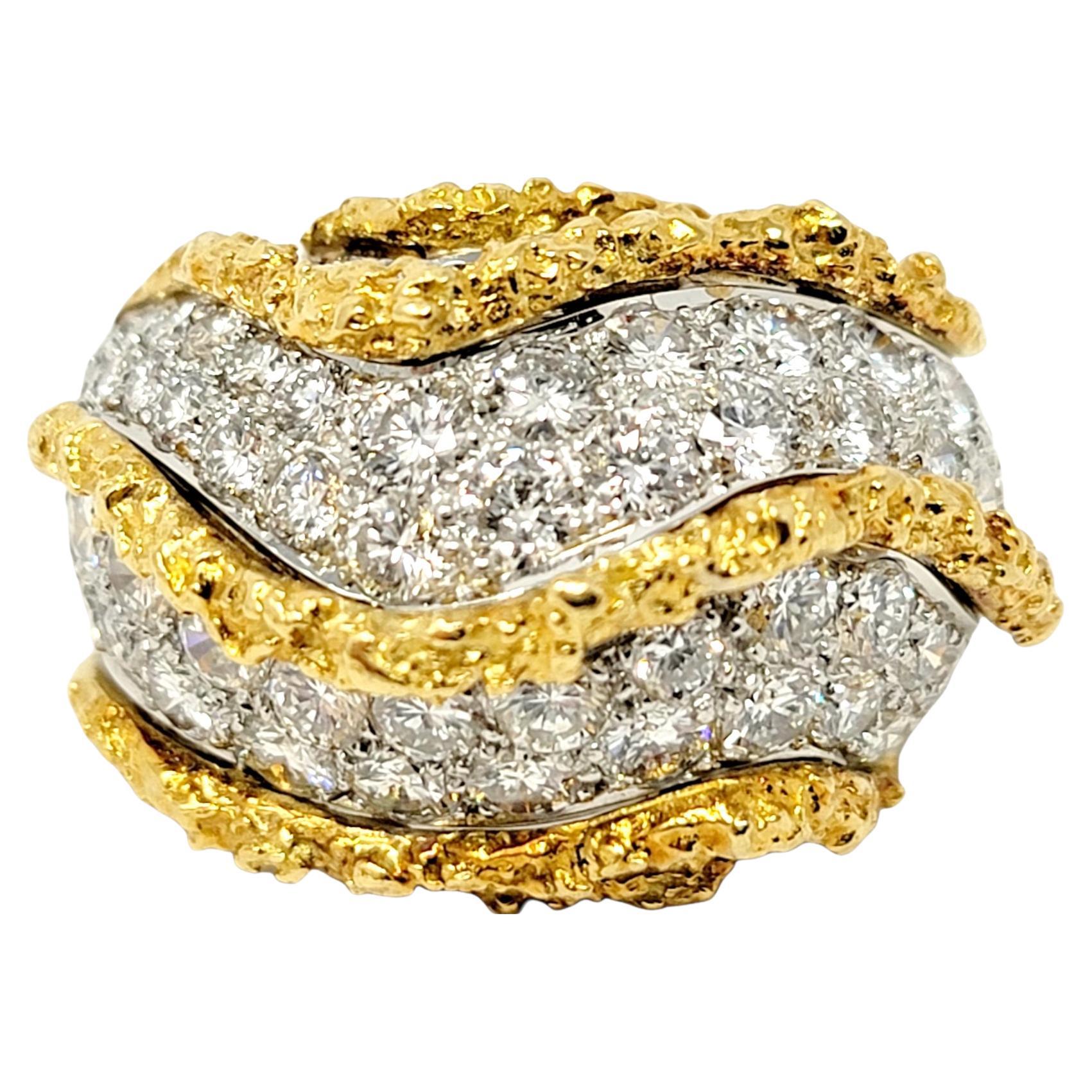 Ring size: 7

Bold and brilliant pave diamond gold river style dome ring will fill your finger with elegance. Substantial in both size and design, this heavy, detailed piece is absolutely exquisite. Textured 18 karat yellow gold ridges stretch
