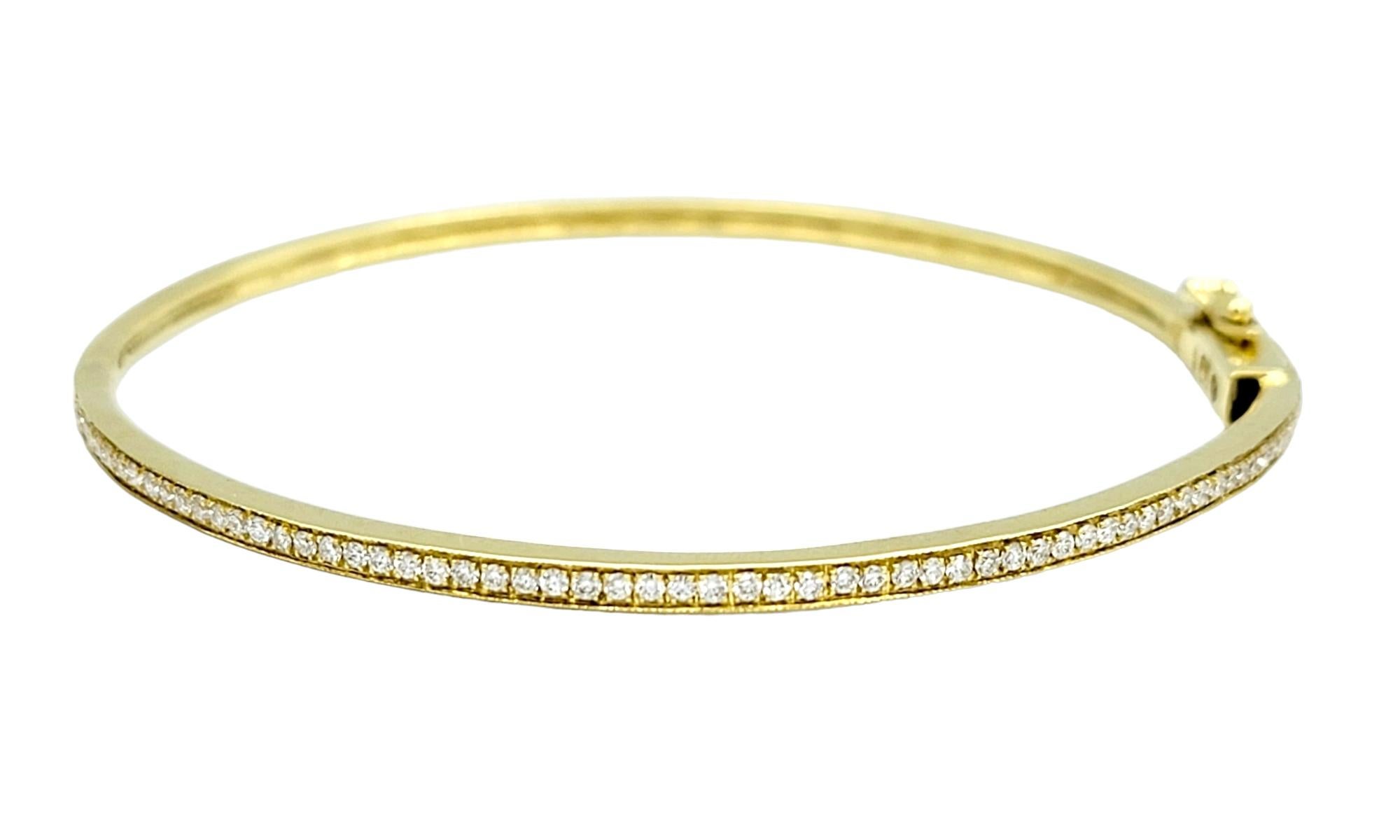 The inner circumference of this bracelet measures 6.38 inches and will comfortably fit a 5.75 - 6.25 inch wrist.

This striking 18 karat yellow gold bangle bracelet is a beautiful fusion of classic elegance and modern luxury. This bangle displays a