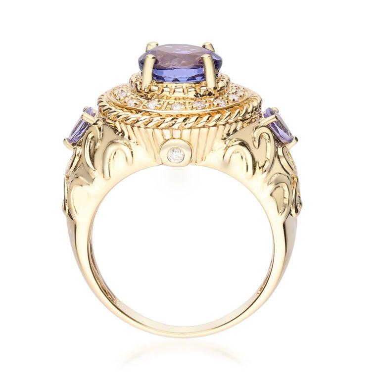 Round Cut Round, Pear-cut Tanzanite With Diamond accents 14K Yellow Gold Ring. For Sale