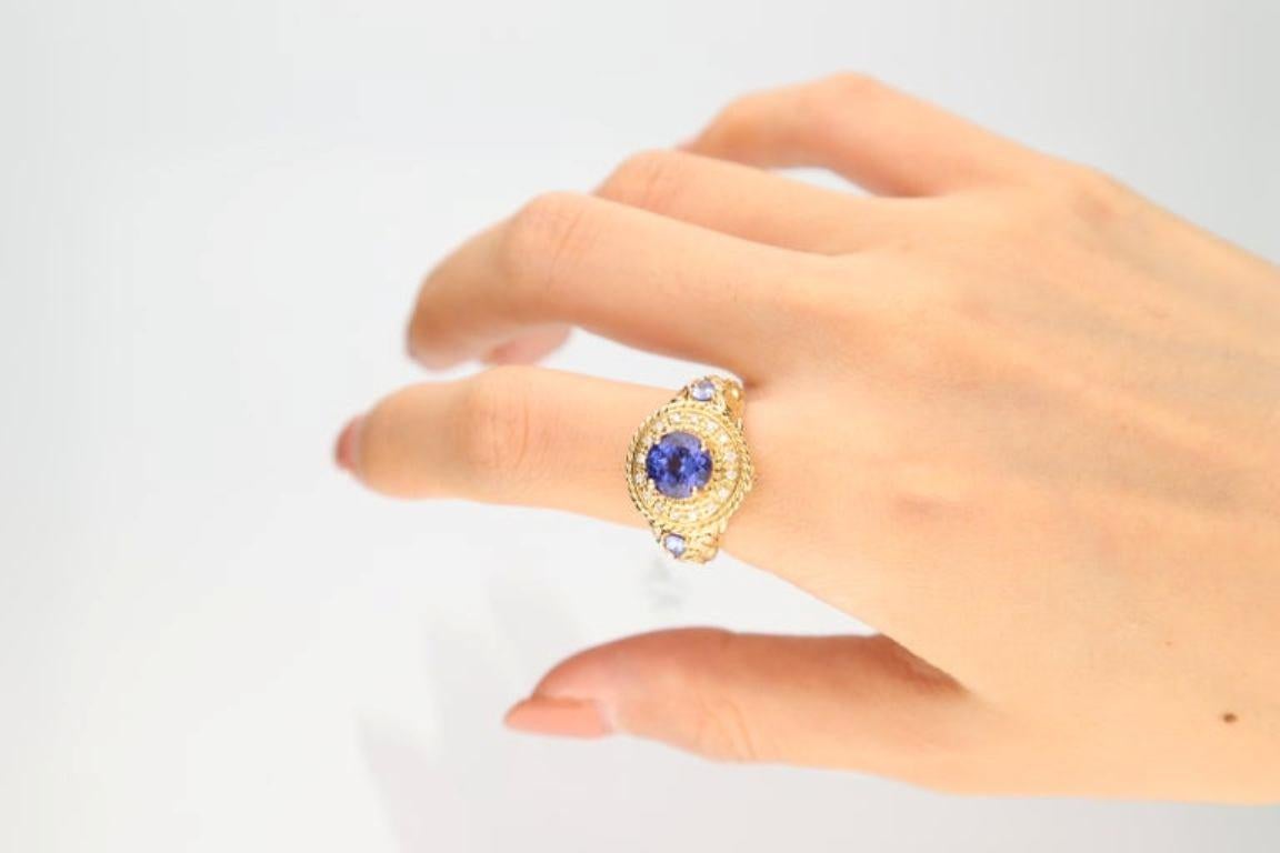 Stunning, timeless and classy eternity Unique ring. Decorate yourself in luxury with this Gin & Grace ring. The 14k Yellow Gold jewelry boasts 8.0 mm Round-Cut Tanzanite (1pcs) 2.25 Carat, 3x4 mm Pear-cut Tanzanite (2pcs) 0.28 carat and Round-Cut