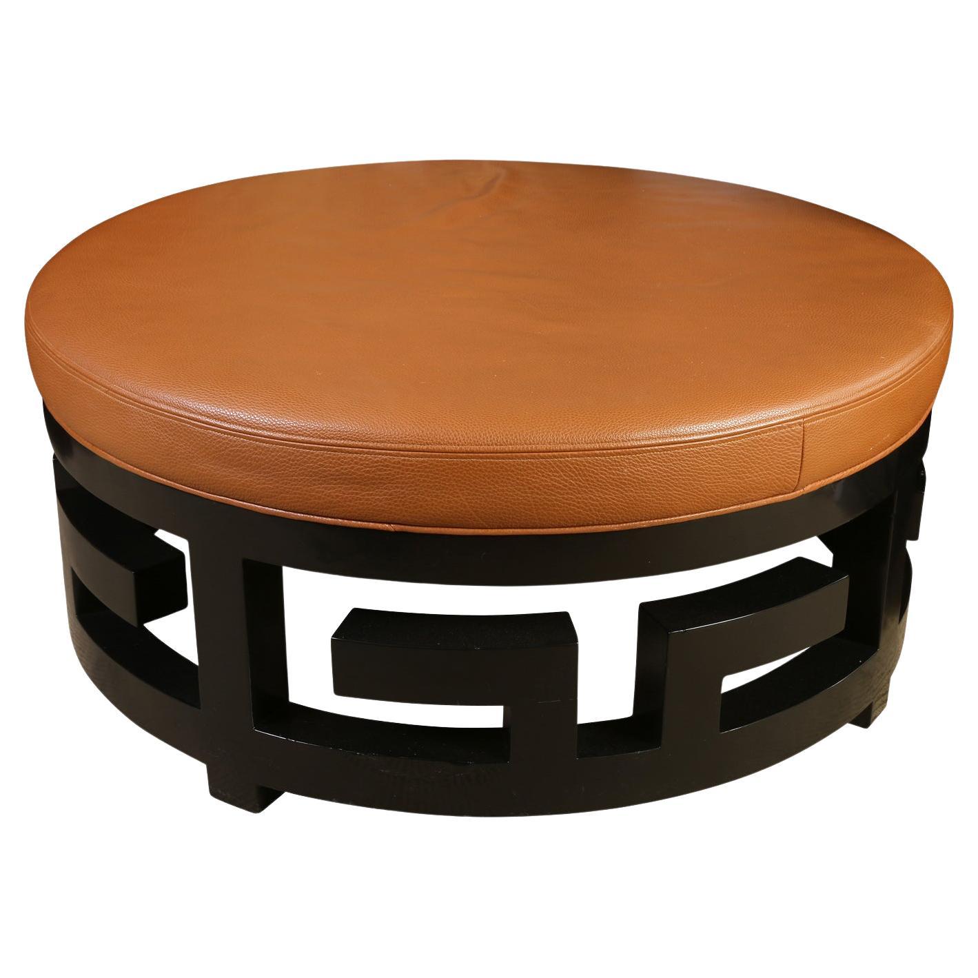 Round Pebbled Leather Ottoman with Black Fretwork Base For Sale