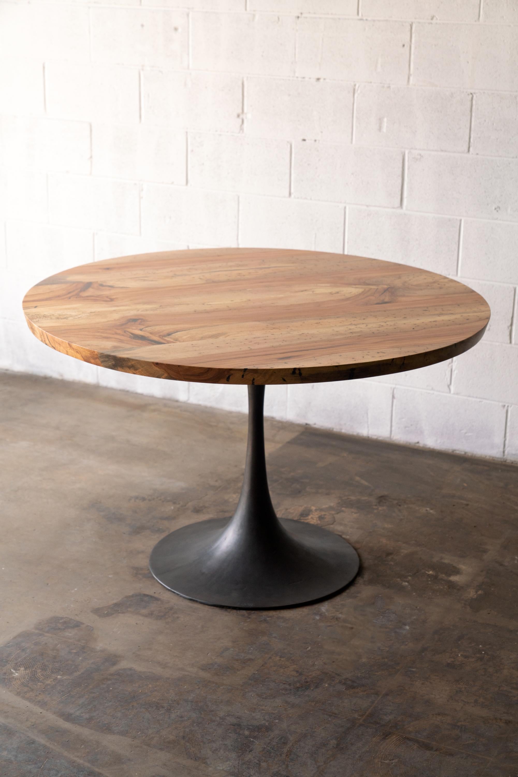 The Amicalola base captures the room set against a round or oval table top. This pedestal base is hand cast by the artisans at Sloss Furnaces historic foundry in Birmingham to look beautiful and function out of the way of diner's feet. Rich with