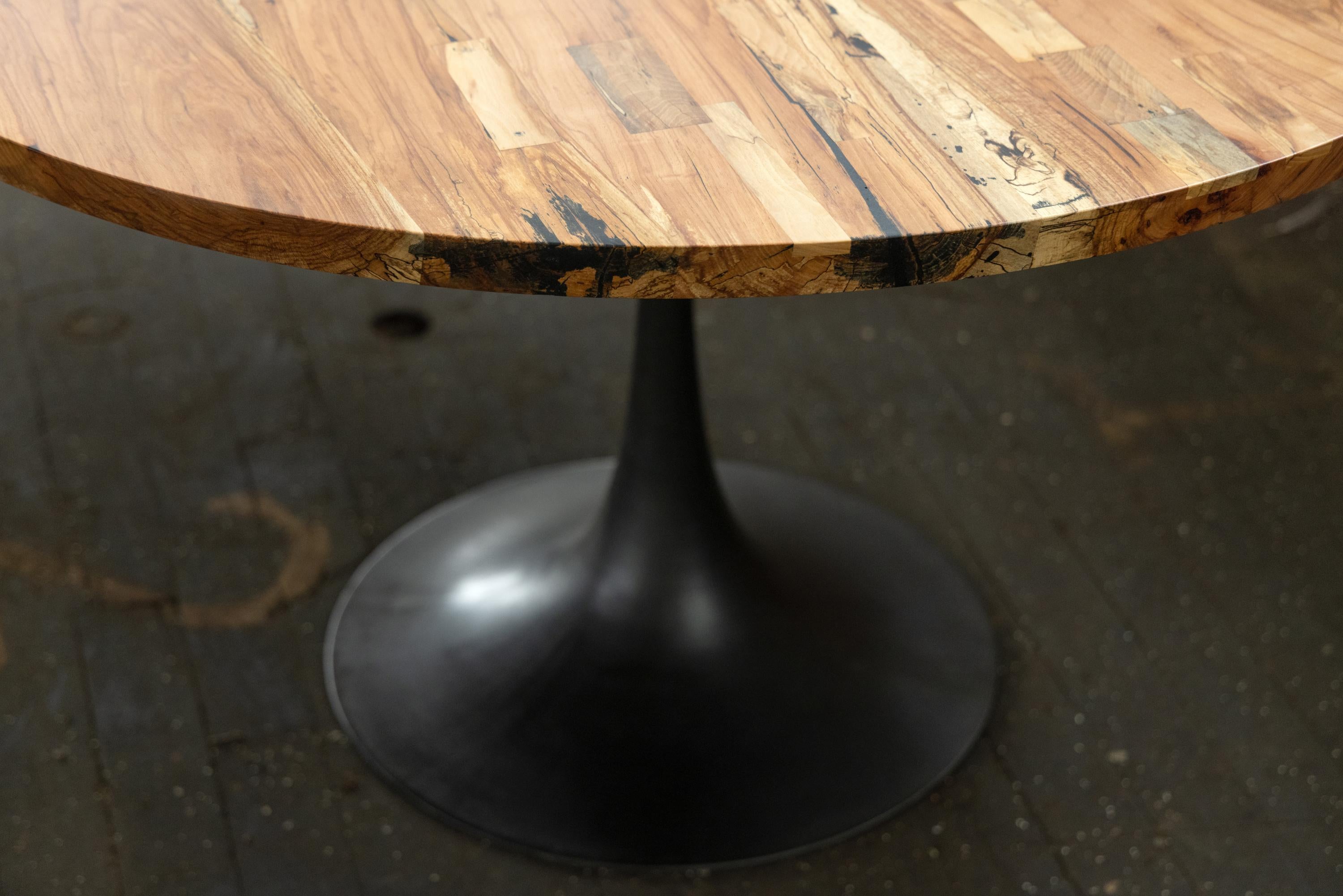 The Amicalola base captures the room set against a round or oval table top. This pedestal base is hand cast by the artisans at Sloss Furnaces historic foundry in Birmingham to look beautiful and function out of the way of diner's feet. Rich with