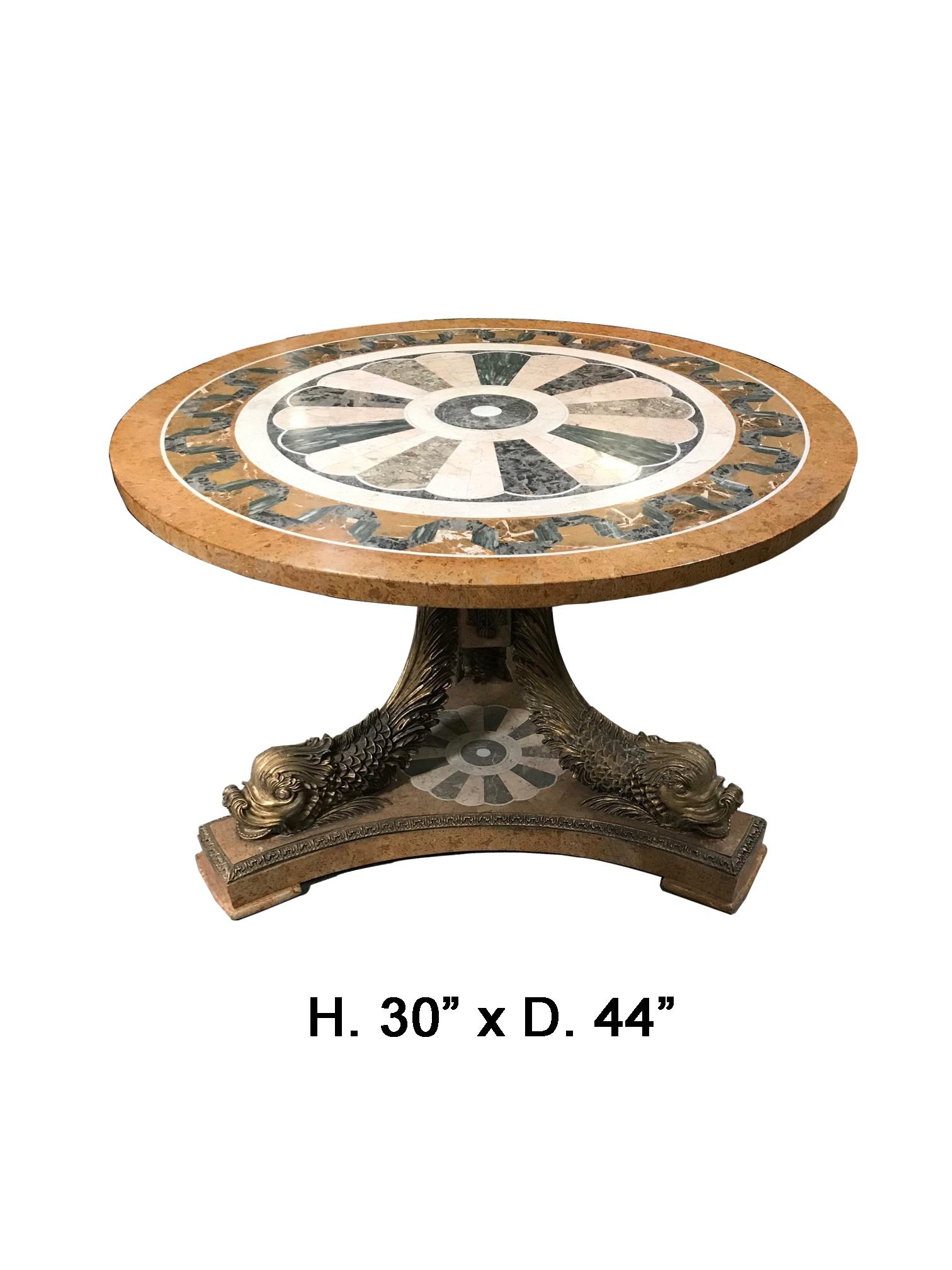 Impressive Italian marble inlaid round pedestal table.
The round top is beautifully veneered and inlaid with various marbles in a very attractive design resting on a tripod pedestal with three beautiful resin gilded dolphins centered with inlaid