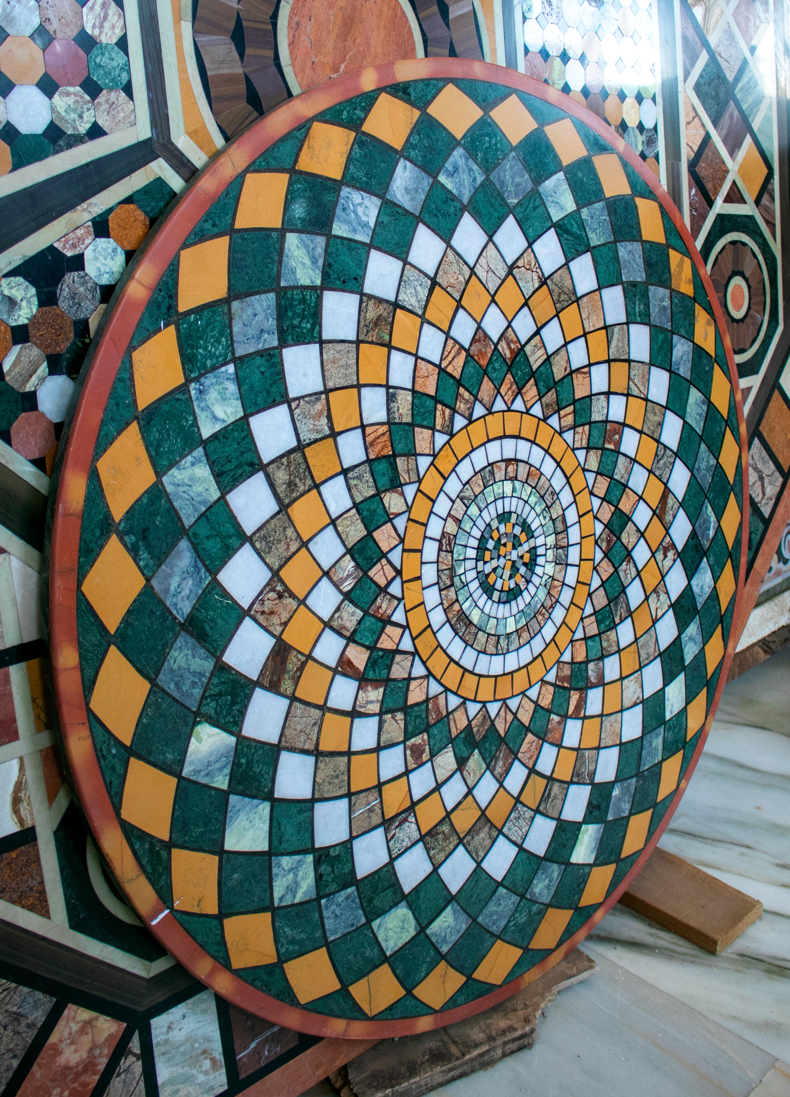 Round Italian geometric pietre dure technique handmade mosaic table top with different marble and semiprecious stones.
  
