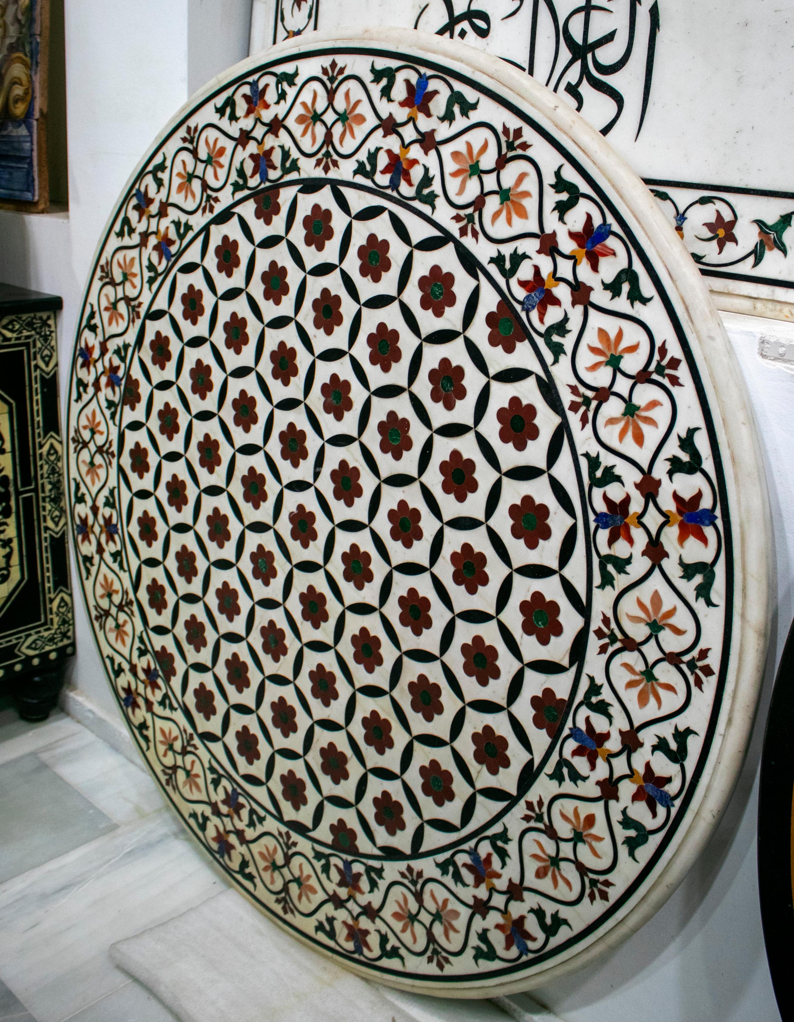 Round Italian geometric pietre dure technique handmade white marble mosaic table top with blue lapis, red amethyst and other semiprecious stones inlay.

  