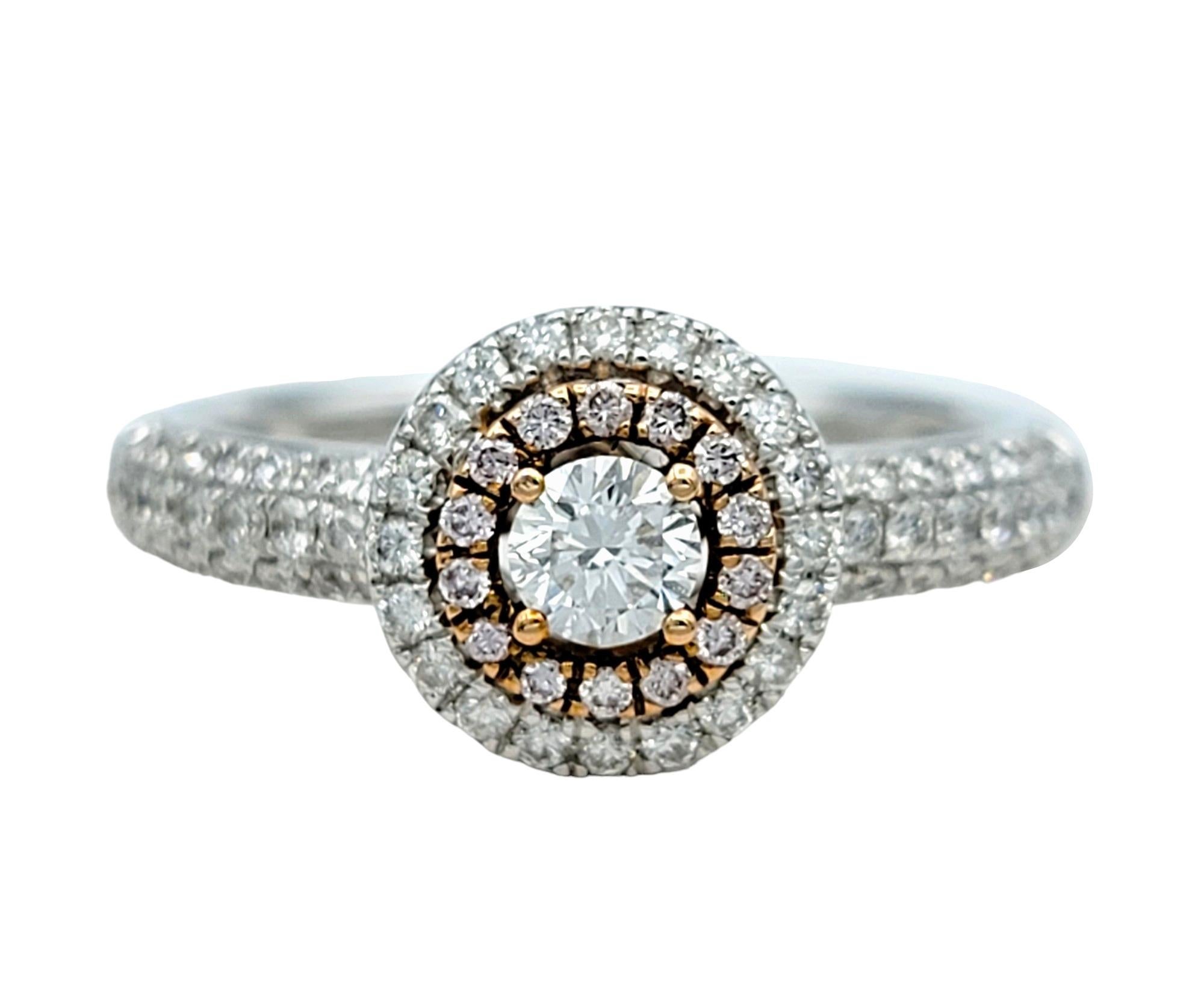 Ring Size: 7

This stunning diamond ring is crafted in lustrous 14 karat white and rose golds, and showcases captivating pink and white diamonds that embody both elegance and femininity. Surrounding the exquisite center white round diamond are not