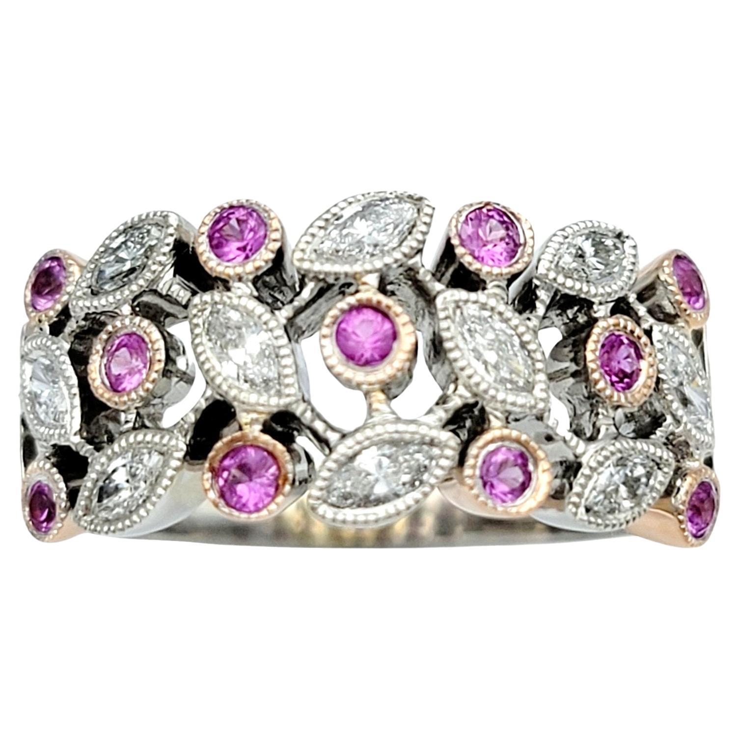 Ring Size: 6

This pink sapphire and diamond band ring is a stunning testament to elegance and sophistication. Crafted in 14 karat white gold, the ring features a mesmerizing blend of pink sapphires and diamonds set in a harmonious leaf motif. The