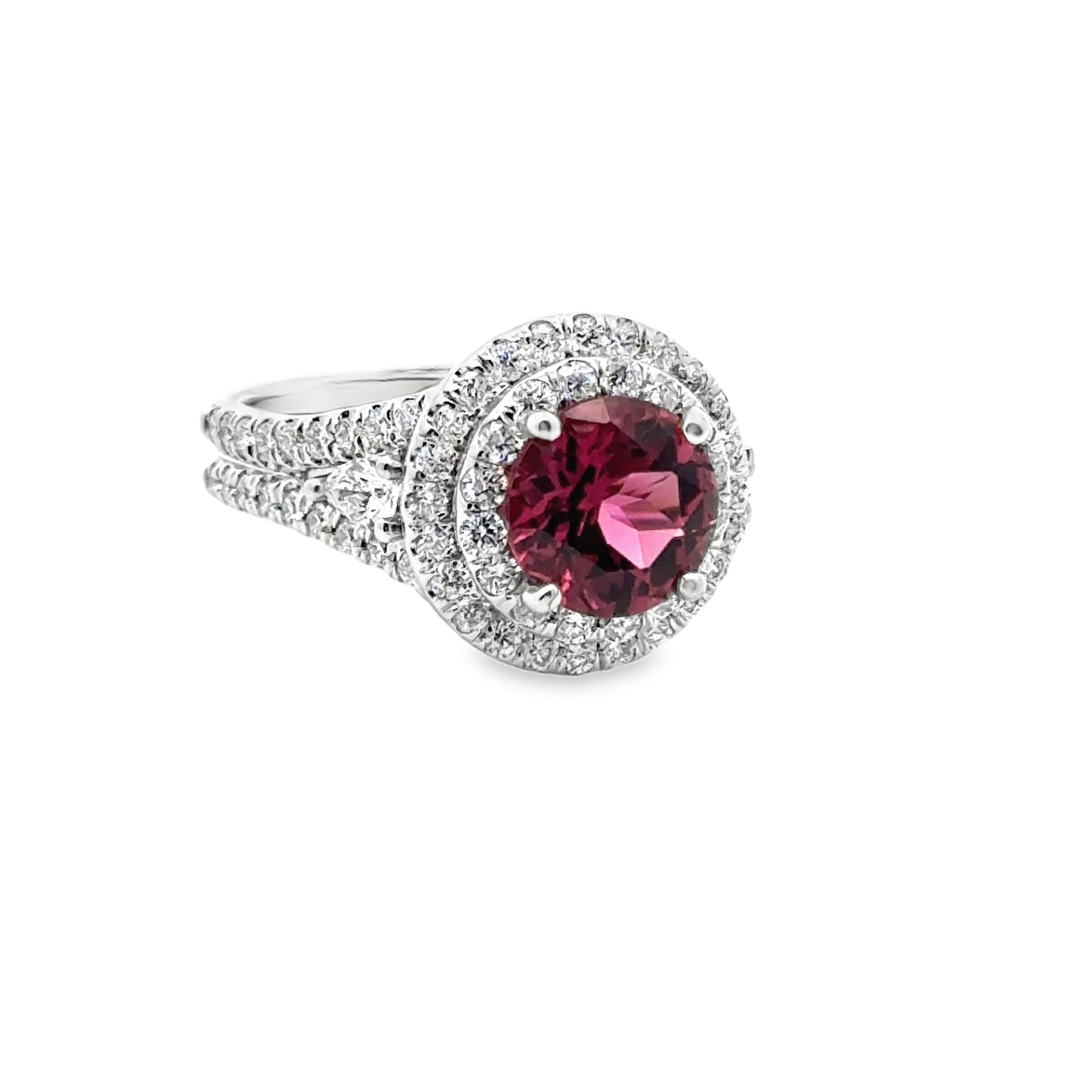 Experience elegance with our 18K white gold estate ring, featuring a stunning 2.03 carat pink tourmaline and 110 round brilliant diamonds. The two pear shaped diamonds complete this exquisite piece, making it a must-have for any collection. Elevate