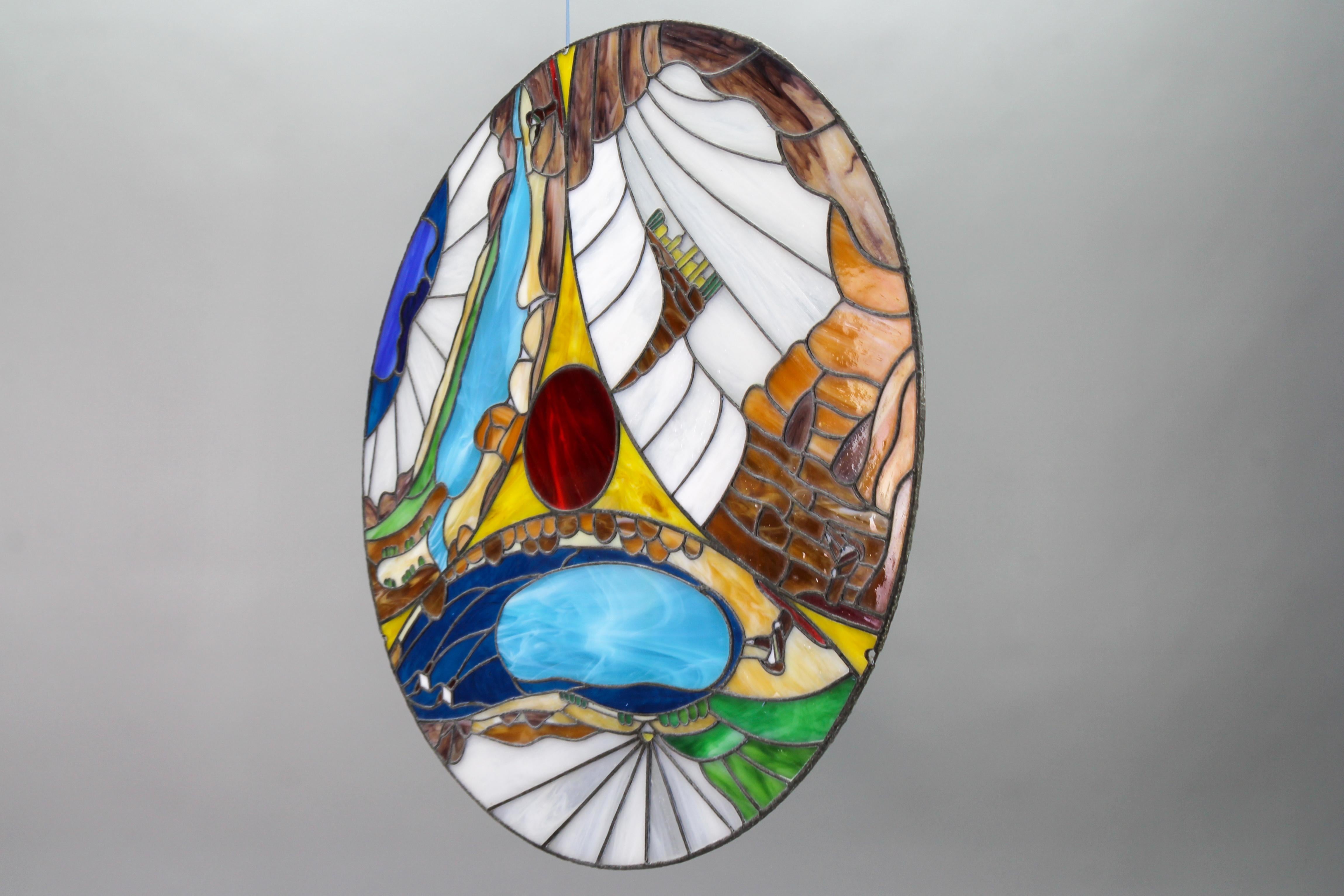 A round polychrome Tiffany-style stained glass window panel, Germany, the 1970s.
This beautiful and large round window decor or panel features an abstract composition in polychrome stained glass in Tiffany style - in blue, white, green, amber,
