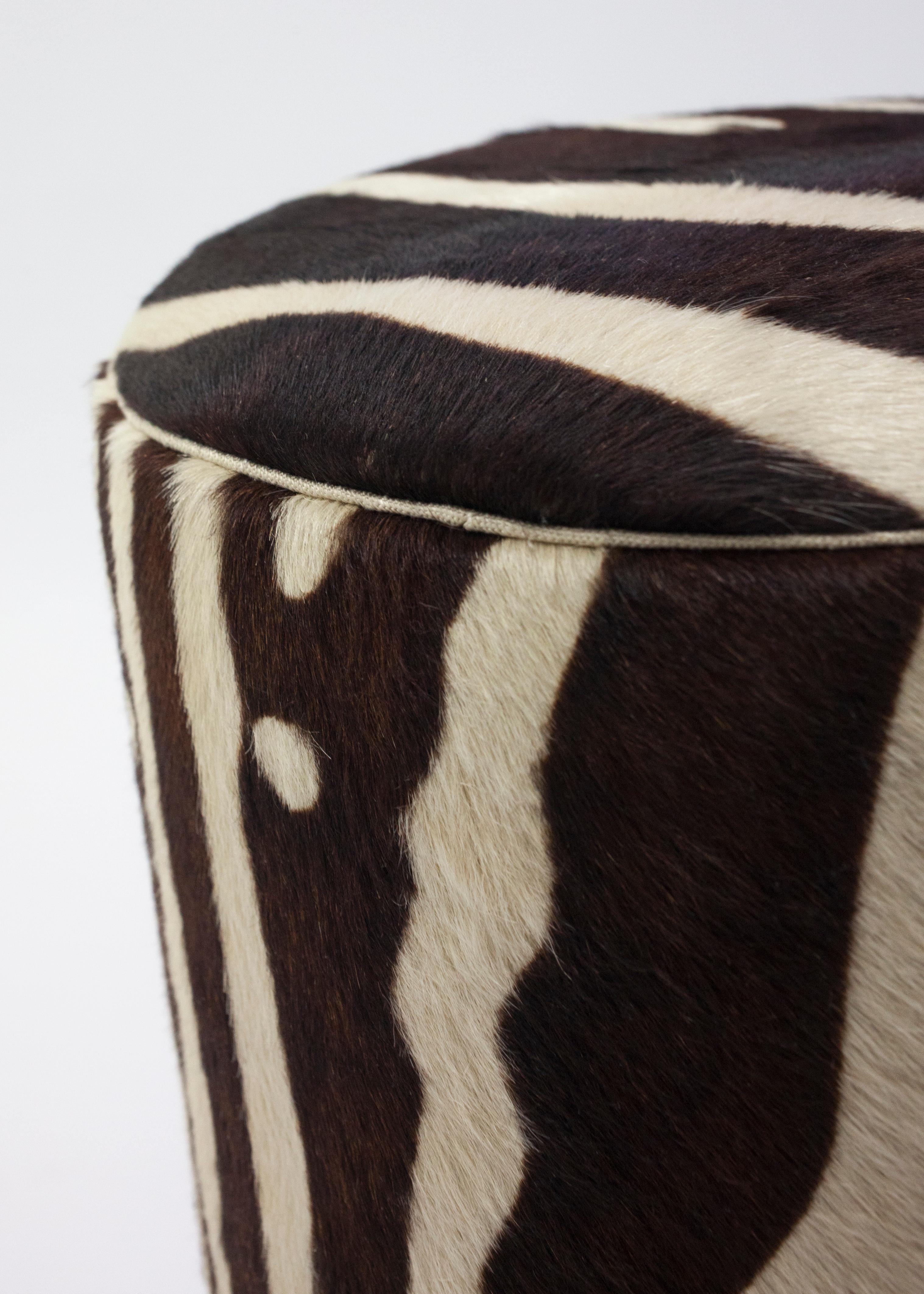 The Lido Pouf is the fun younger sister to the Colle pouf shown in faux animal skin with a steel metal base - it can be used as an ottoman or pull up table and can be made custom to suit your needs in both size and covered in customers own