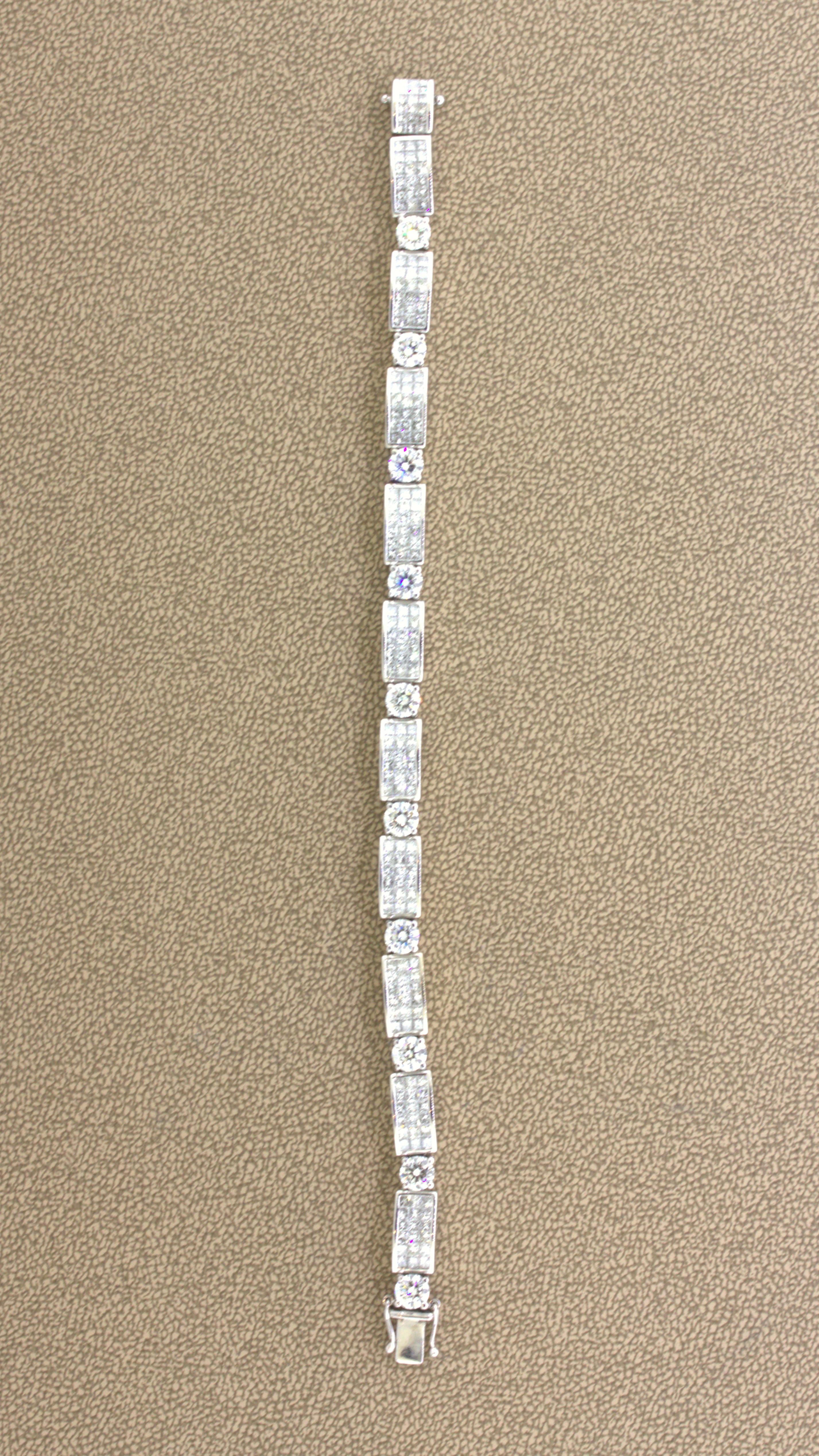 A sweet and stylish diamond bracelet featuring 10 large round brilliant-cut and smaller invisible-set princess-cut diamonds. The total diamond weight is 14.22 carats, and they have a clarity grade of VS1-VS2 and color grade of G-H. Very fine bright