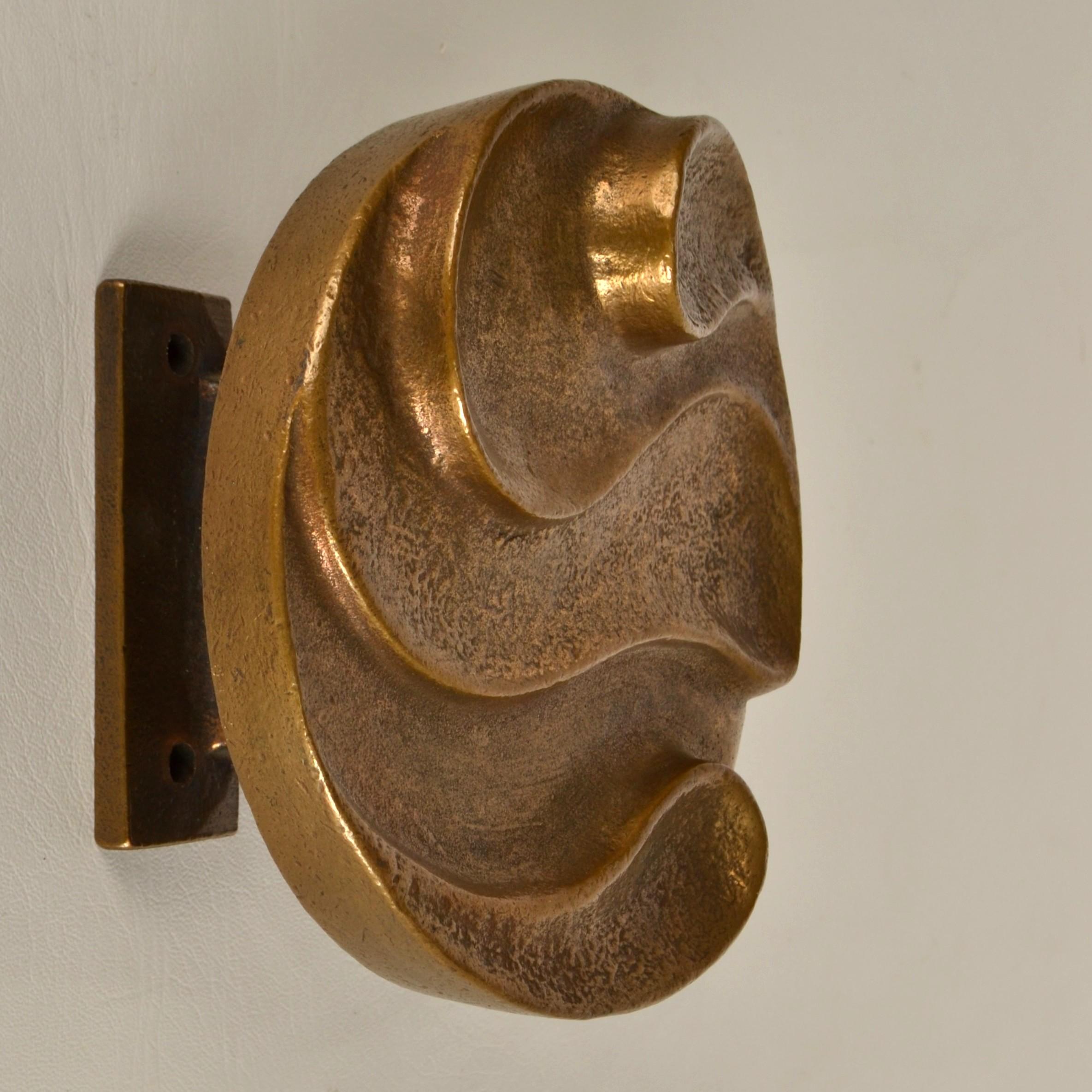 Single round door handle with curvaceous snake relief that is part  textured. Cast bronze relief in perfect condition. The bronze has a subtitle patina due to the textured surface and its age, circa 1970's. 
It will create personality to any door.