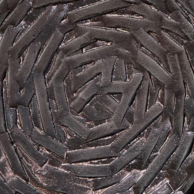 Single round door handle with spiralling relief that is  textured. Cast bronze relief in perfect condition. The bronze has a subtitle patina due to the textured surface and its age, circa 1970's. 
Artistic door handle will create personality to any