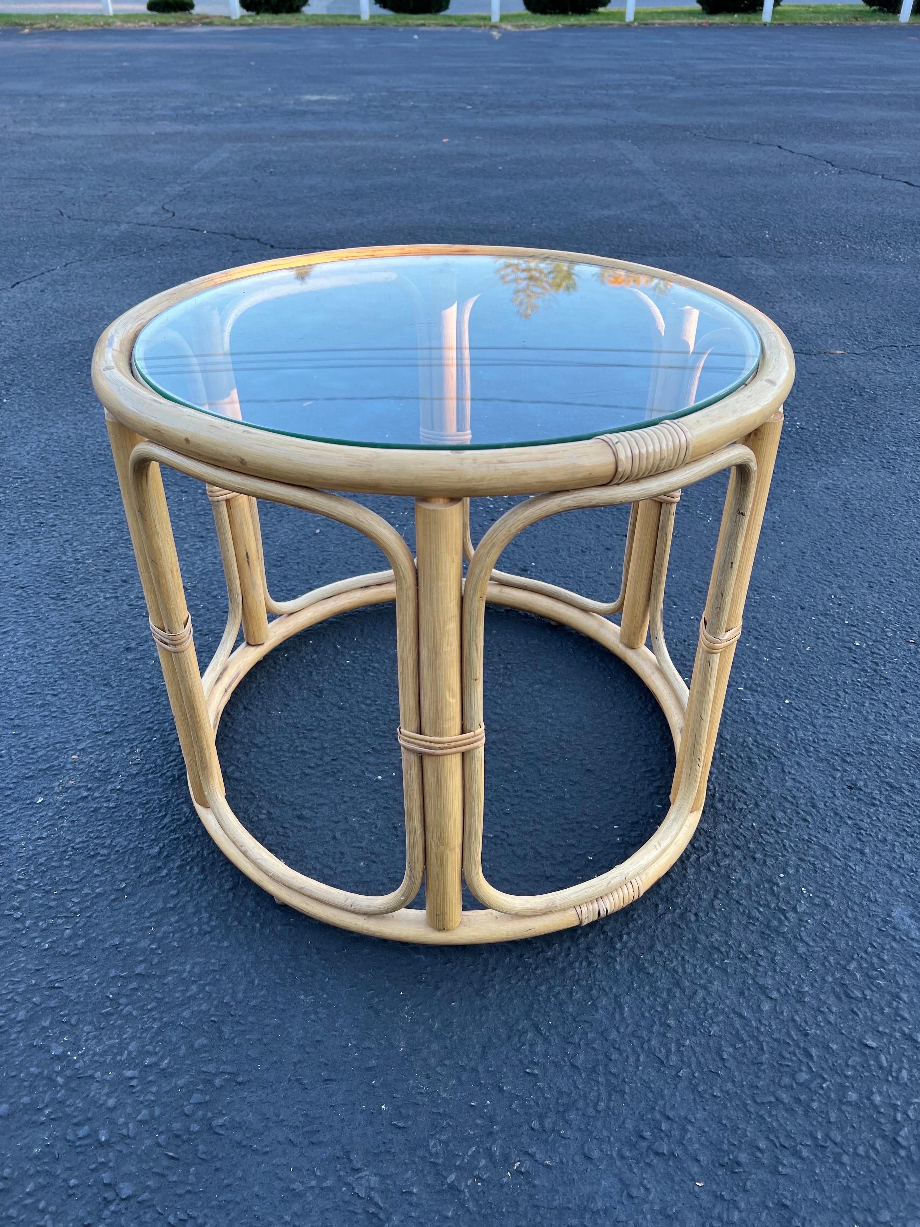 Round rattan and faux bamboo side table. Classic boho style table. Simple, organic design. We have a matching pair of rattan swivel chairs to flank this lovely table
 