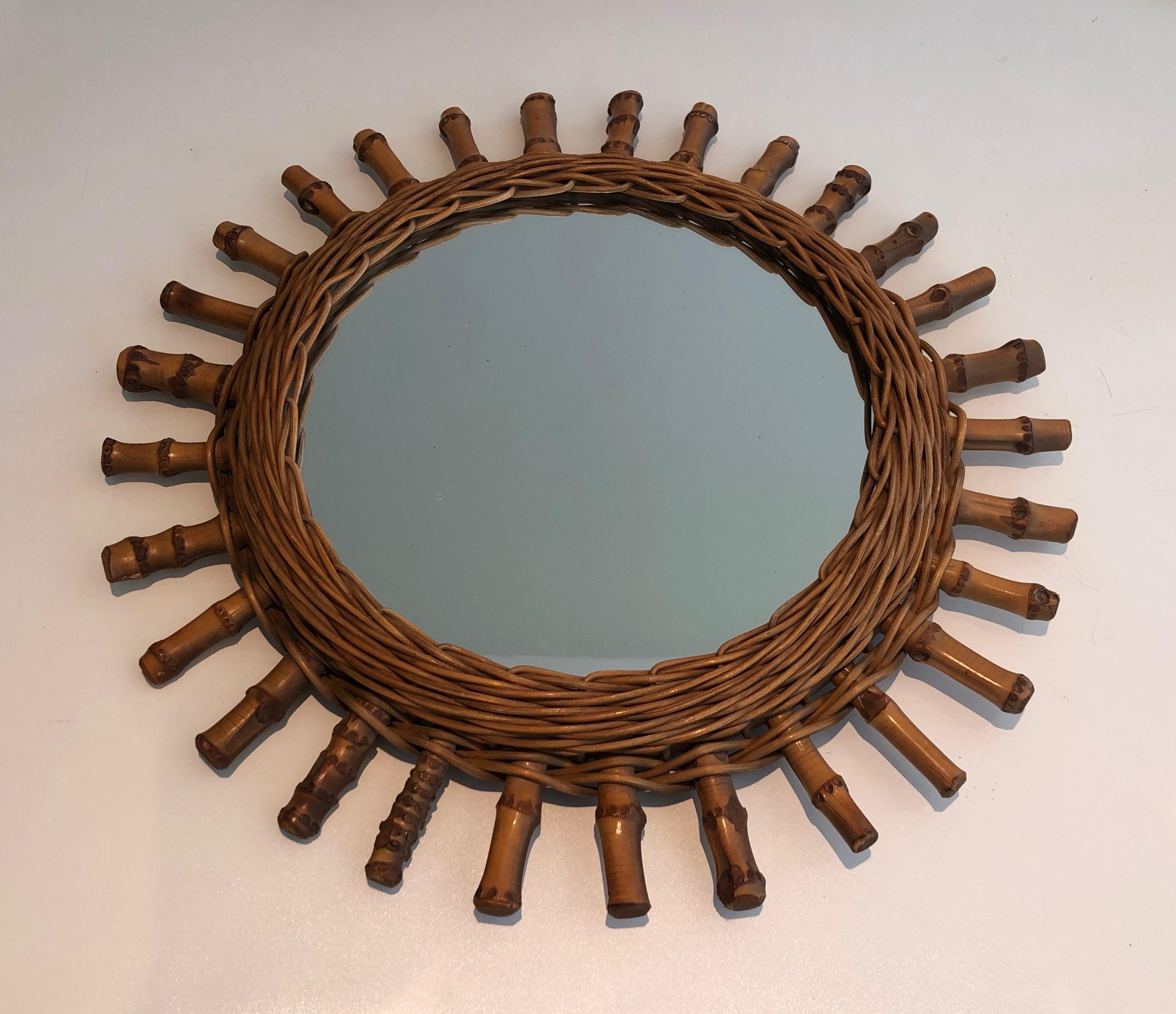 This round mirror is made of rattan. This is a French work. Circa 1970.