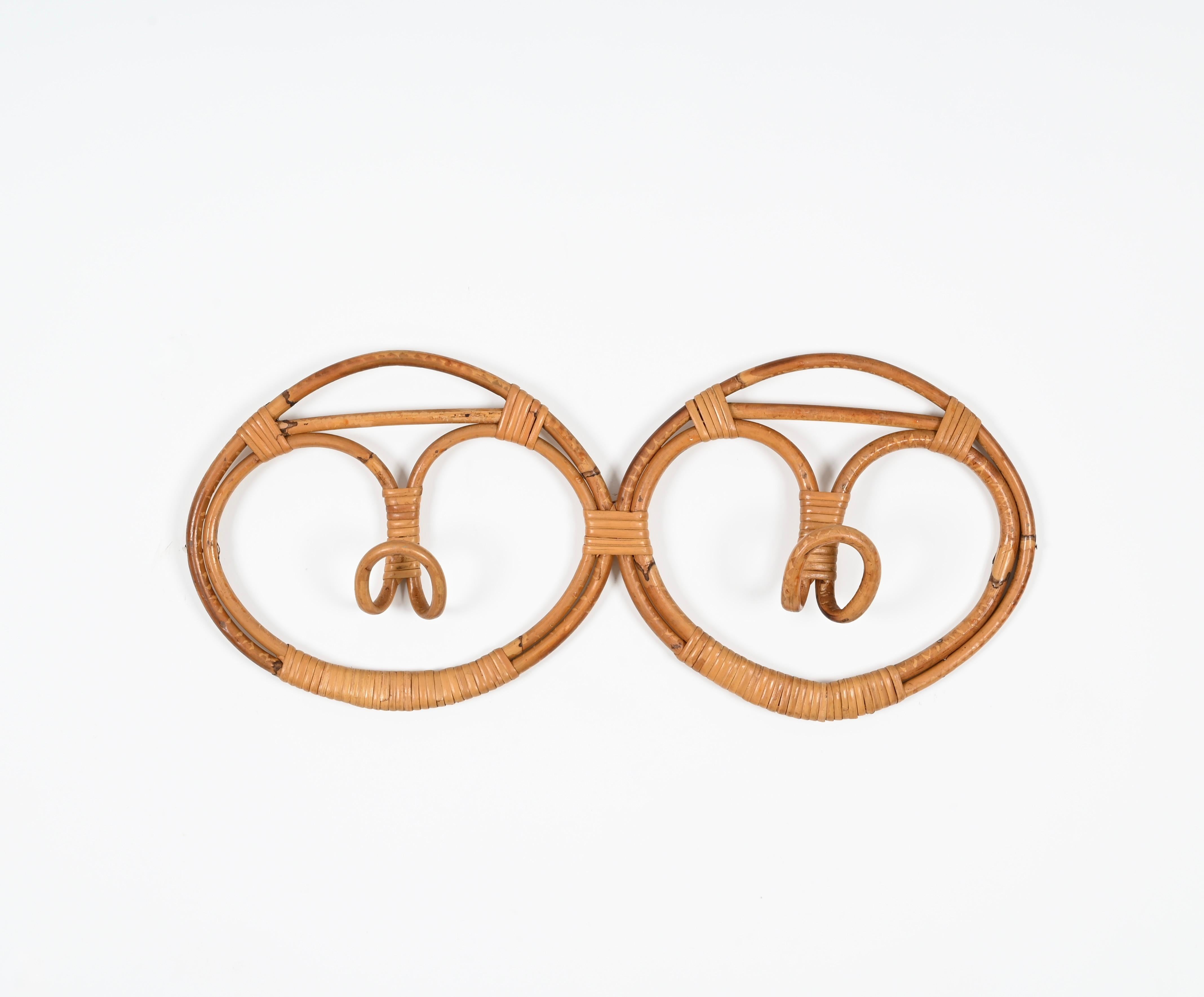 Stunning Mid-Century coat rack in rattan and hand-woven wicker designed by Franca Helg and Franco Albini in Italy during the 1960s.  

This gorgeous French Riviera style coat rack is made with perfect proportions in curved rattan and woven wicker.
