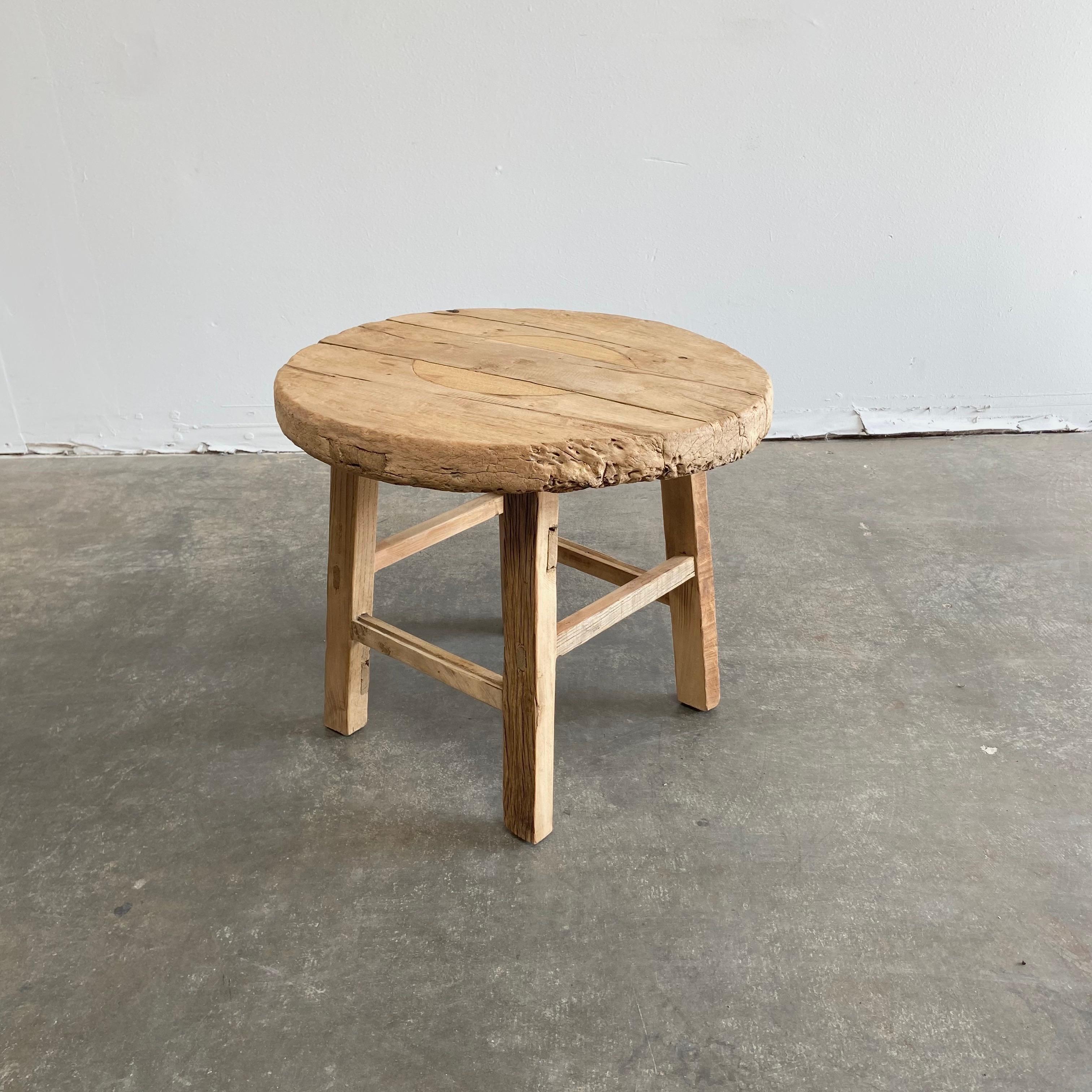 Round natural side table made from reclaimed elmwood Raw natural finish, a warm honey tone in the wood. Solid and sturdy, a great side table for next to a bed, sofa, chairs. Can be stained or painted for a customized look
Size: 23” RD. x 20” H.