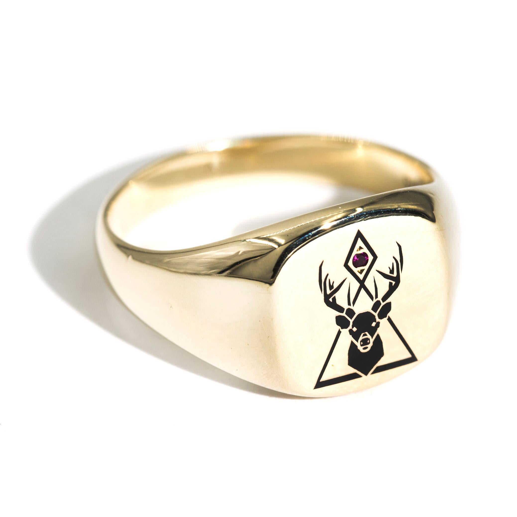 Forged in 9 carat yellow gold is this handsome mens solitaire vintage signet ring that features a black enamelled reindeer head beset with a single round red ruby.  We have named this dapper vintage ring The Kingston Ring. The Kingston Ring has