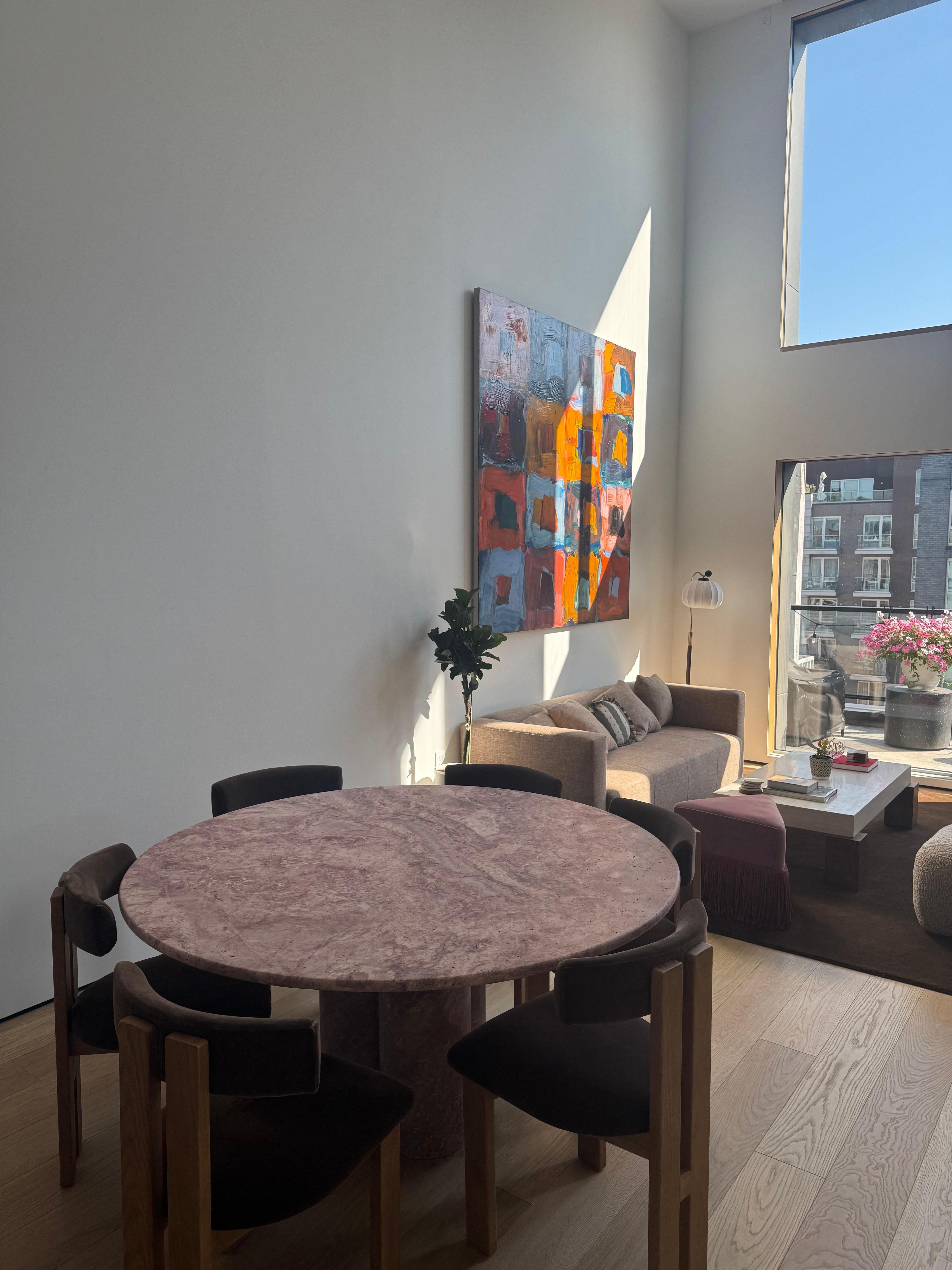 This minimalist table is made from one material, featuring a curved edge top that elegantly sits on four cylindrical columns, giving this table a sculptural feel. 

Drawing inspiration from the vintage pieces of Mario Bellini, the honed matt finish