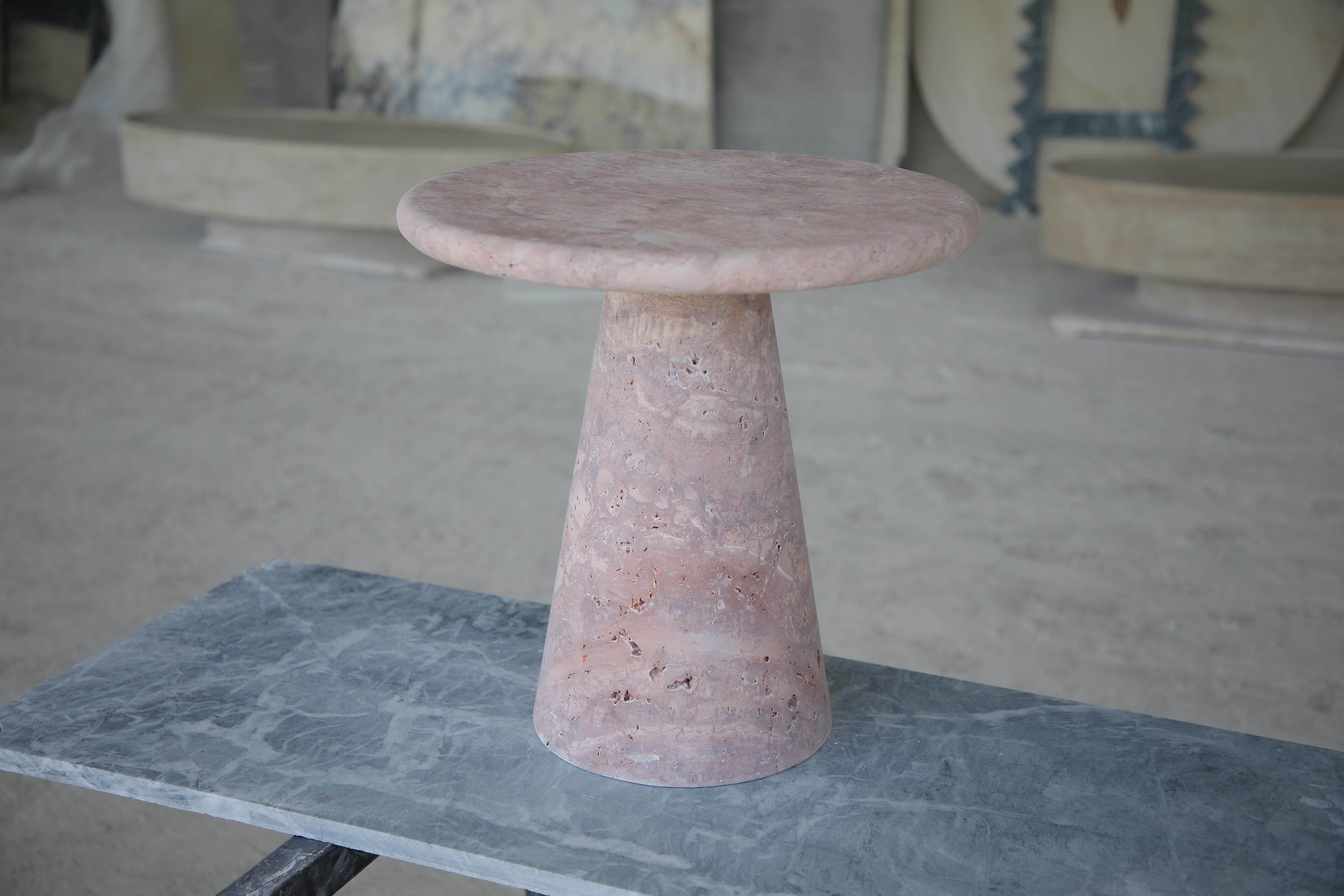 This minimalist table is crafted from Red Travertine showcasing a circular tabletop that balances securely and effortlessly with its own weight.

Inspired by the iconic vintage designs of Angelo Mangiarotti, the sculptural column base adds an