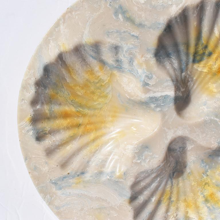 Round stone resin seashell serving dish or platter. The piece is very heavy and is blue, light gray and yellow in color. Three indentions in the shape of shells for serving oysters, or for use as a catch-all. 

Dimensions: 
3.6 lbs
9