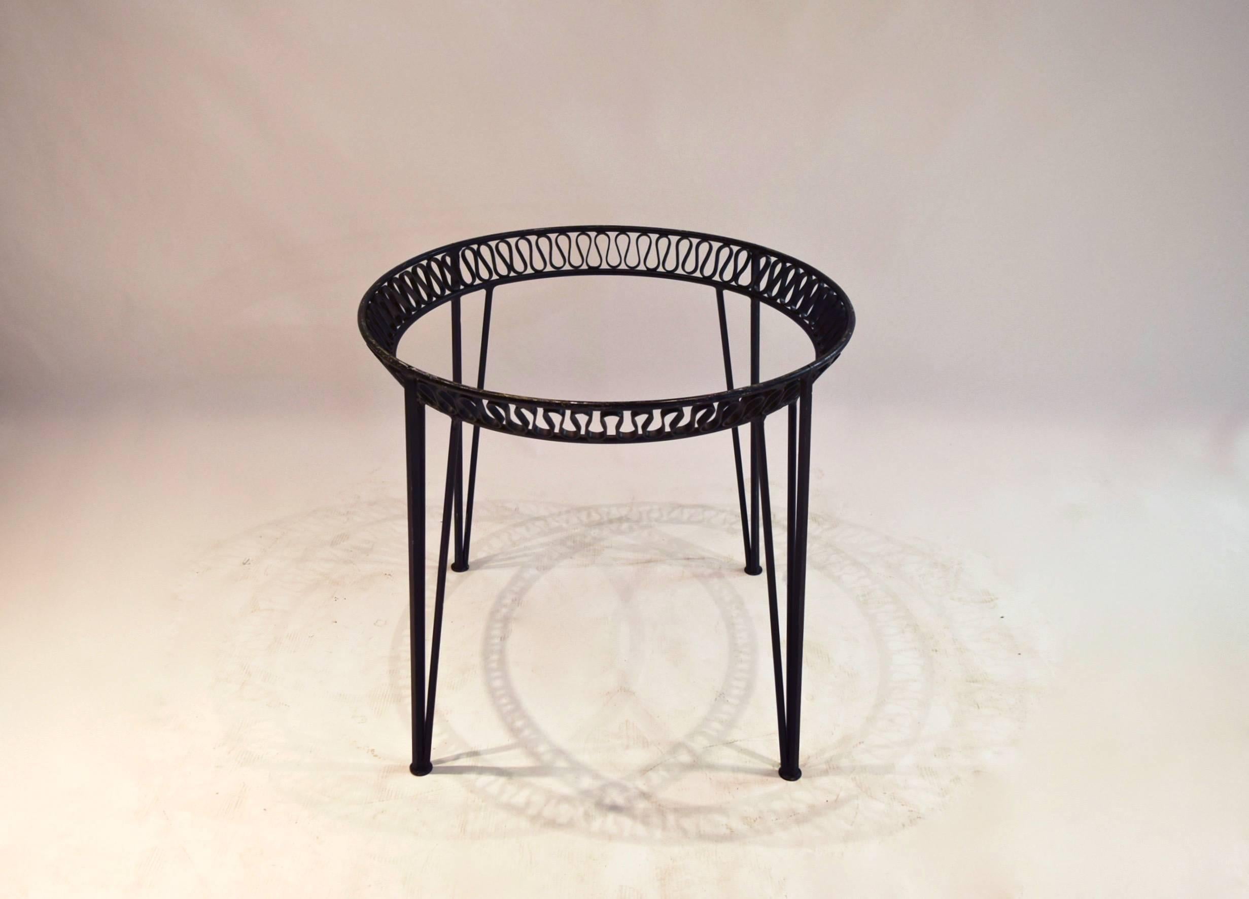 Black enameled metal round dining table from Salterini's 