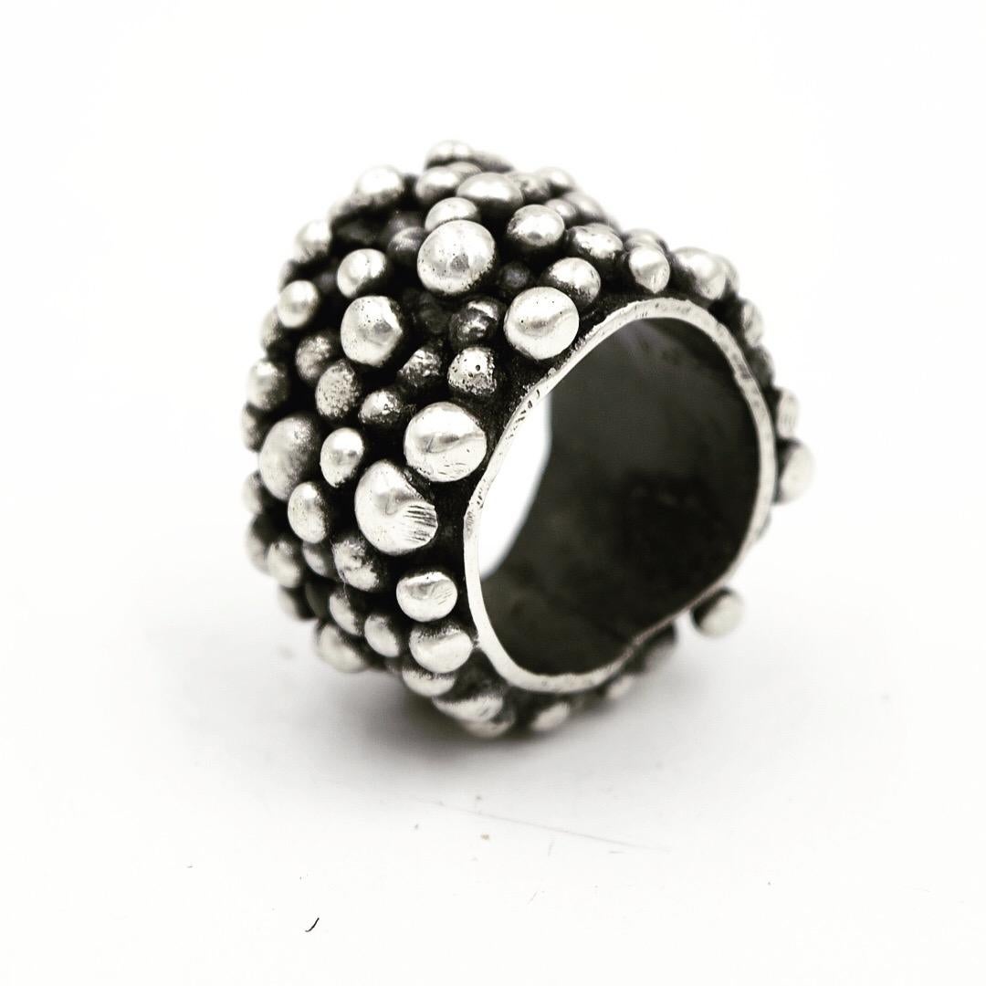 Granulation is the technique in which you use small scraps of precious metal with heat to create a perfectly spherical shape.

In other words, I take small pieces of Sterling silver and set them on a charcoal block in which I have created