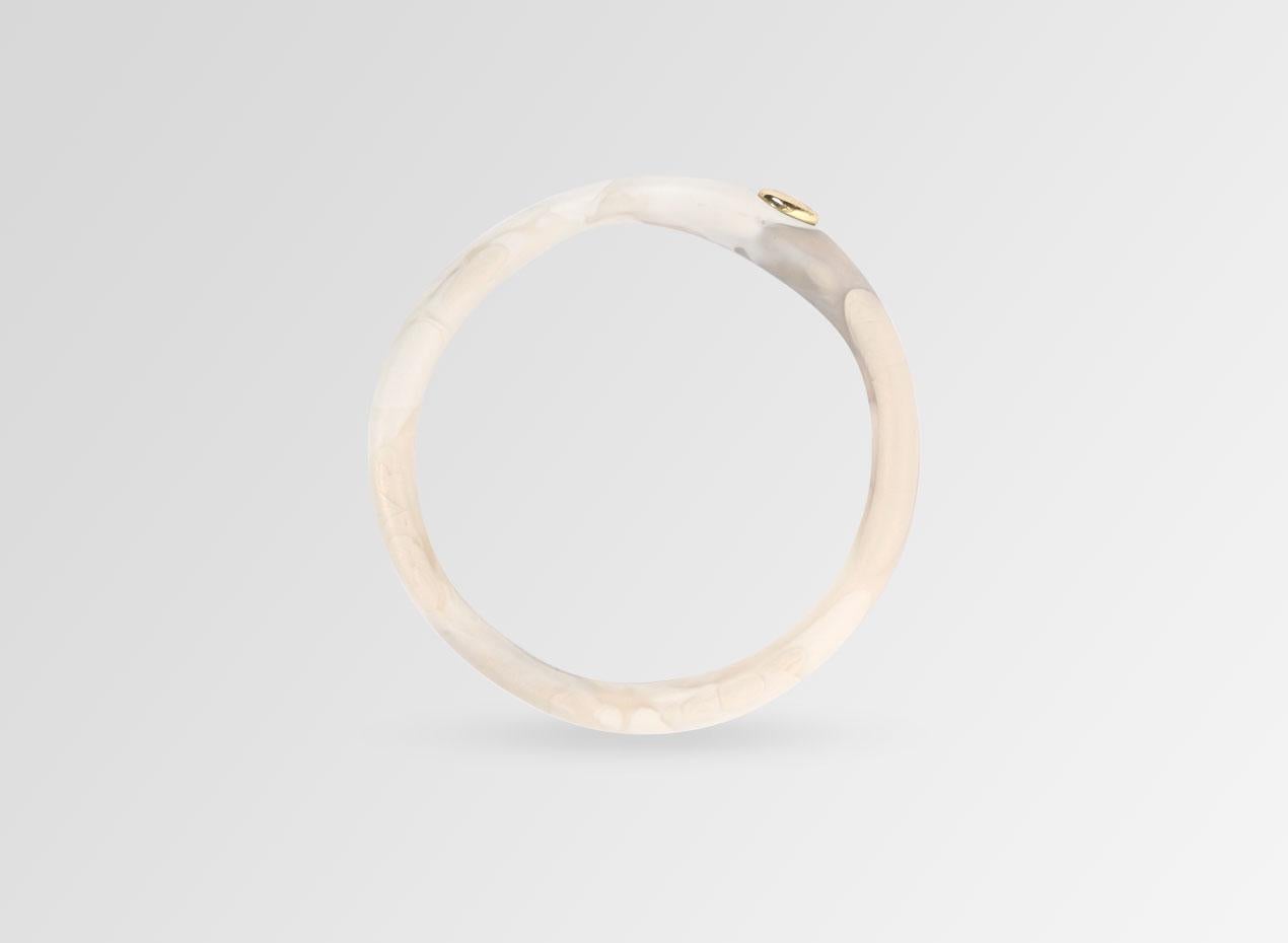 Resin bangle with brass bead detail. This bangle is featured in our Classic colour, Sandy Pearl. 

Dinosaur Designs resin products are hand made in Sydney, Australia. Each piece is unique and we cannot guarantee you will receive an item exactly