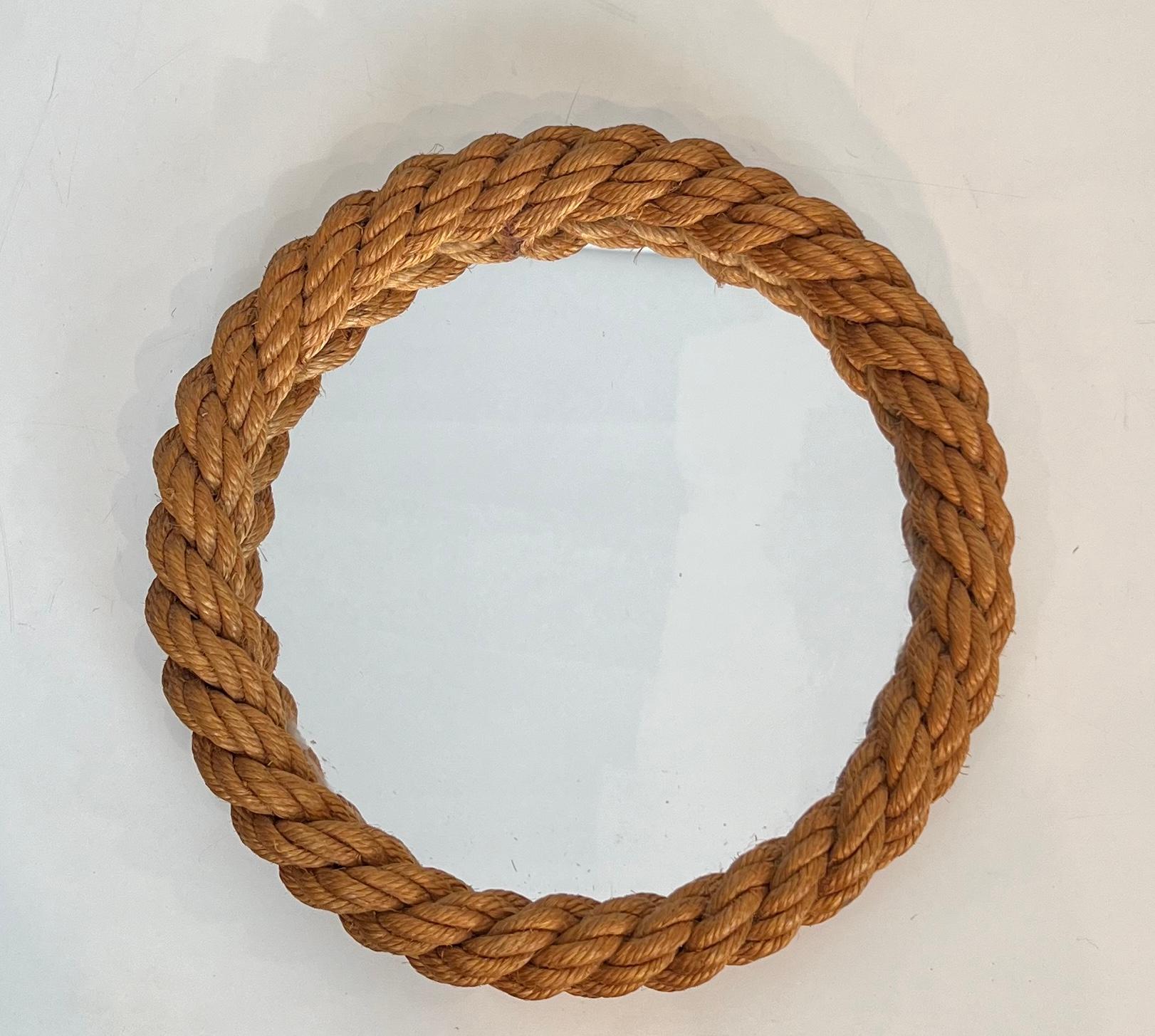 This very nice round mirror is all made of rope surrounding the mirror. This is a French work by Adrien Audoux and Frida Minet (Audoux-Minet). Circa 1950
