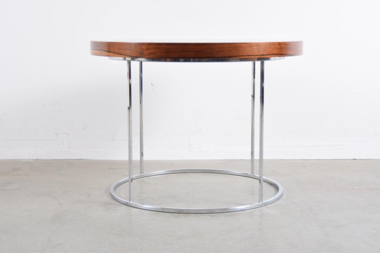 Round rosewood and chrome lamp / end table, designed by Milo Baughman, circa 1978. Beautifully figured rosewood top. Table stands 19 3/4