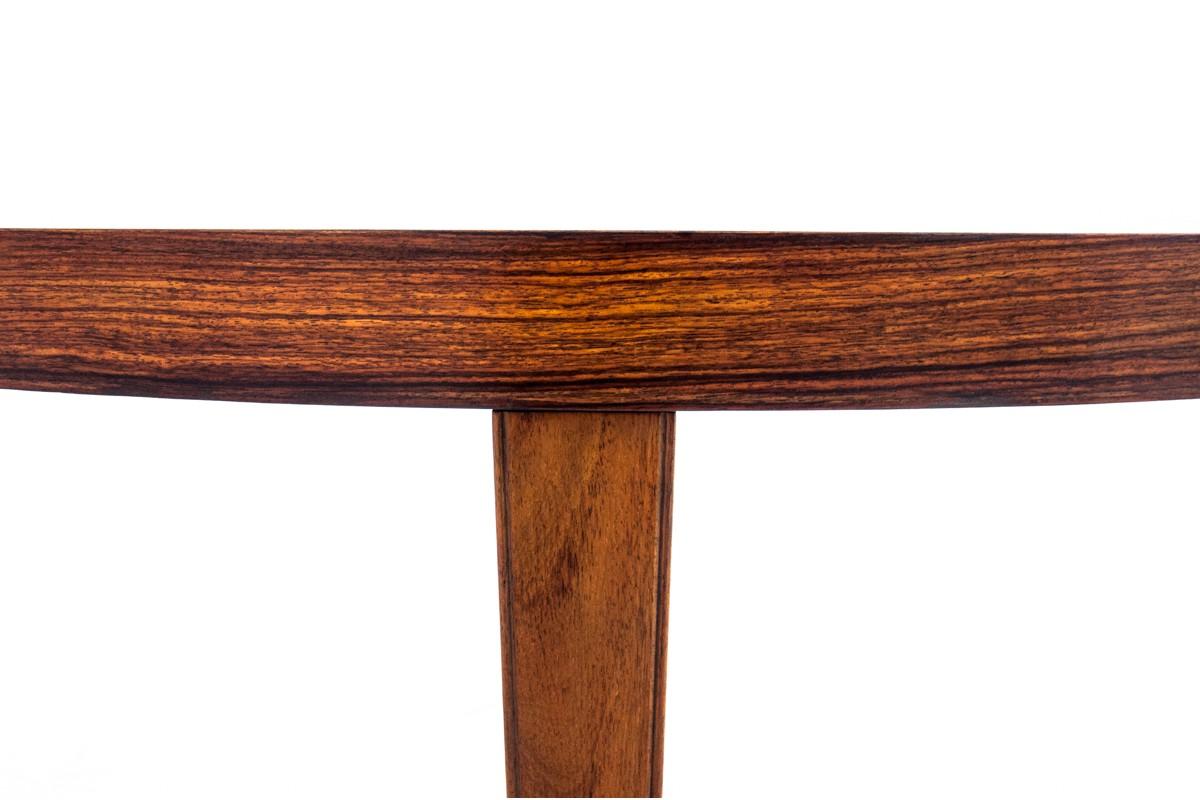 Table manufactured in Denmark in the 1960s.

Table veneered with rosewood with beautiful grain. The table can be extended and has one insert. Its timeless form will fit perfectly into contemporary interiors. The furniture has original labels on the