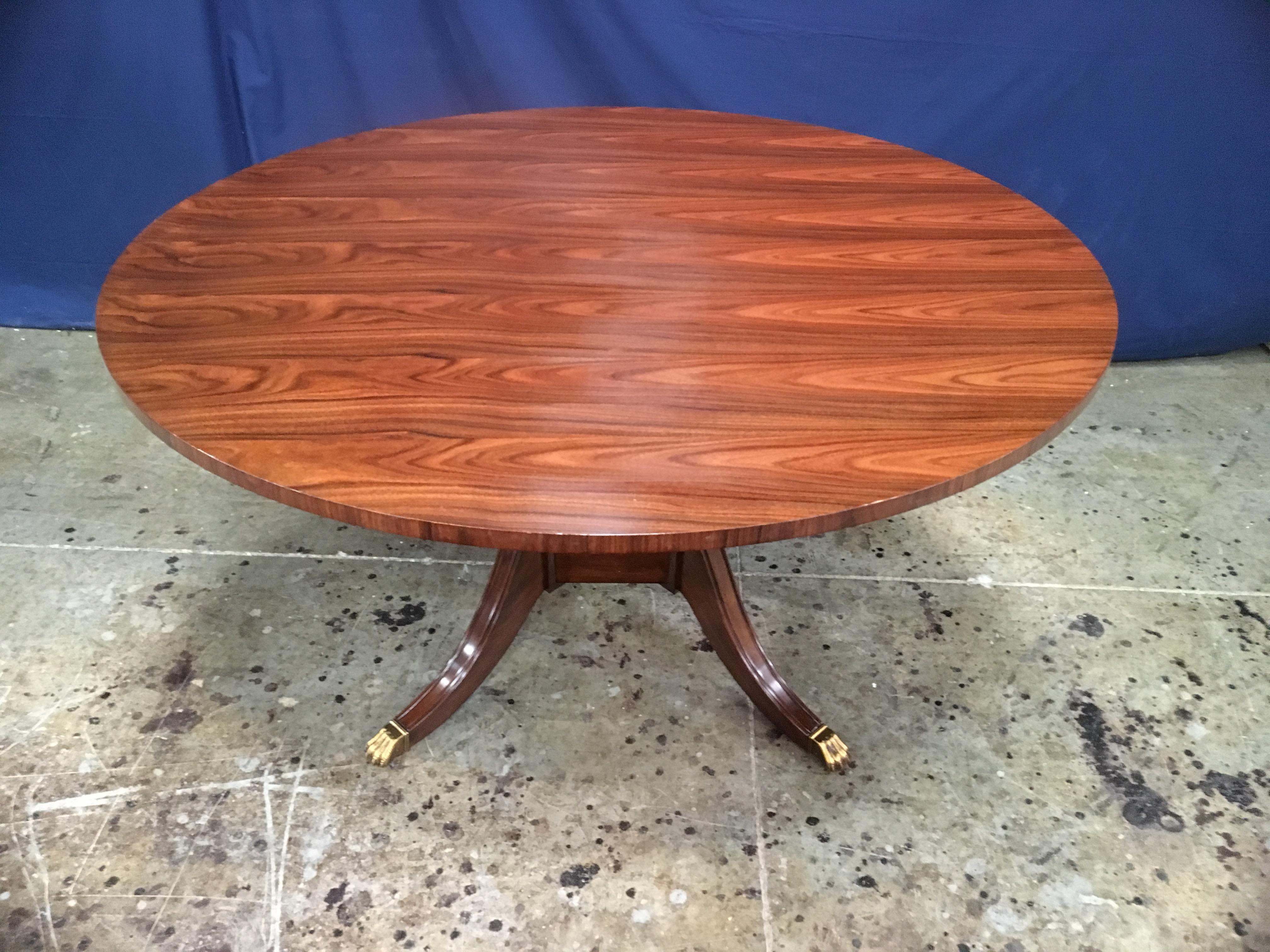 This is made-to-order round traditional Santos Rosewood top dining table made in the Leighton Hall shop. It features a field of slip-matched Santos Rosewood. The top has a hand rubbed and polished semigloss finish. The large birdcage pedestal has