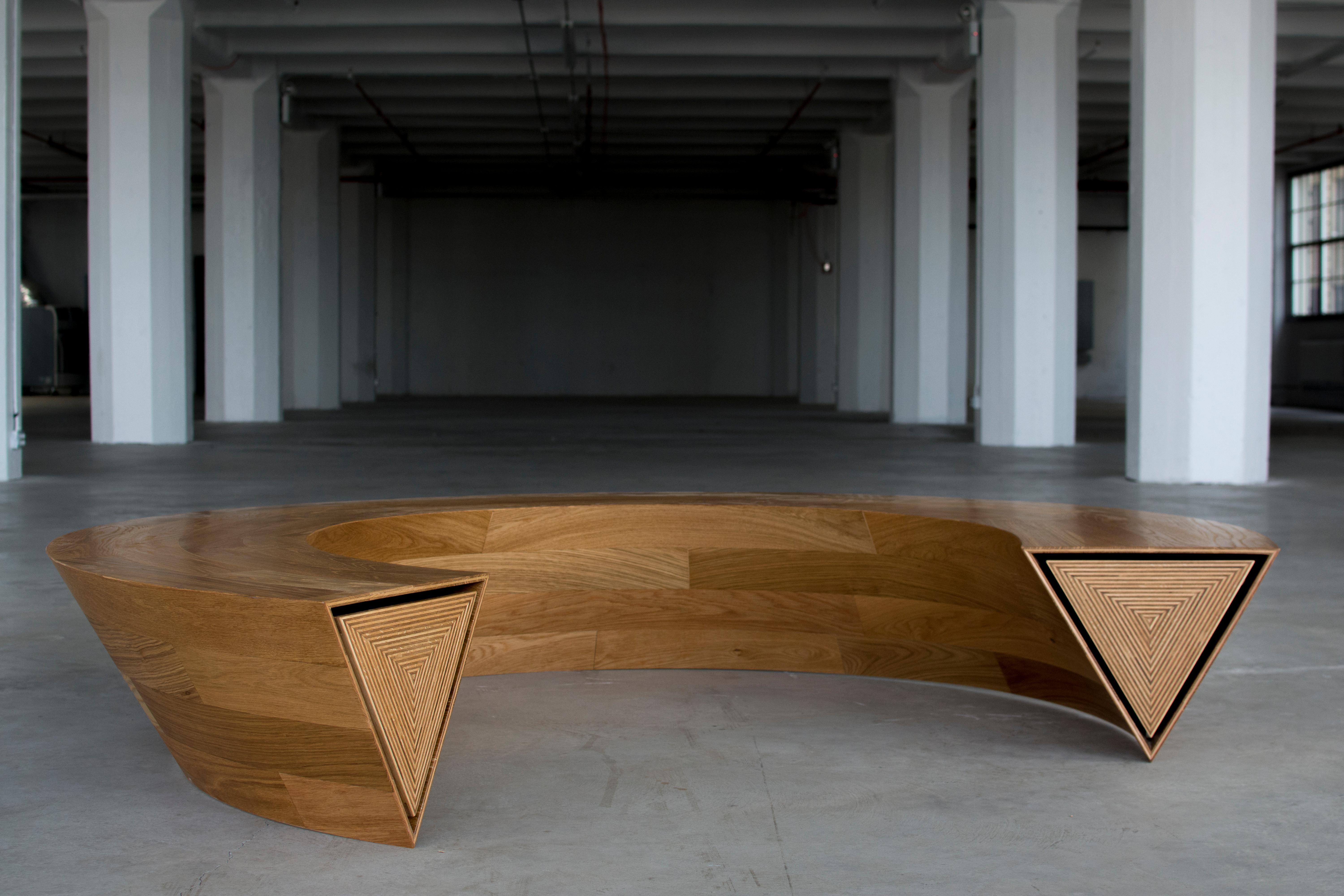 Round & Round is a circular communal bench and storage unit that is balanced on one single line. Though appearing to be a solid mass, as one end of the bench is pushed, the opposing side pops open revealing itself to be a continuous hidden drawer.