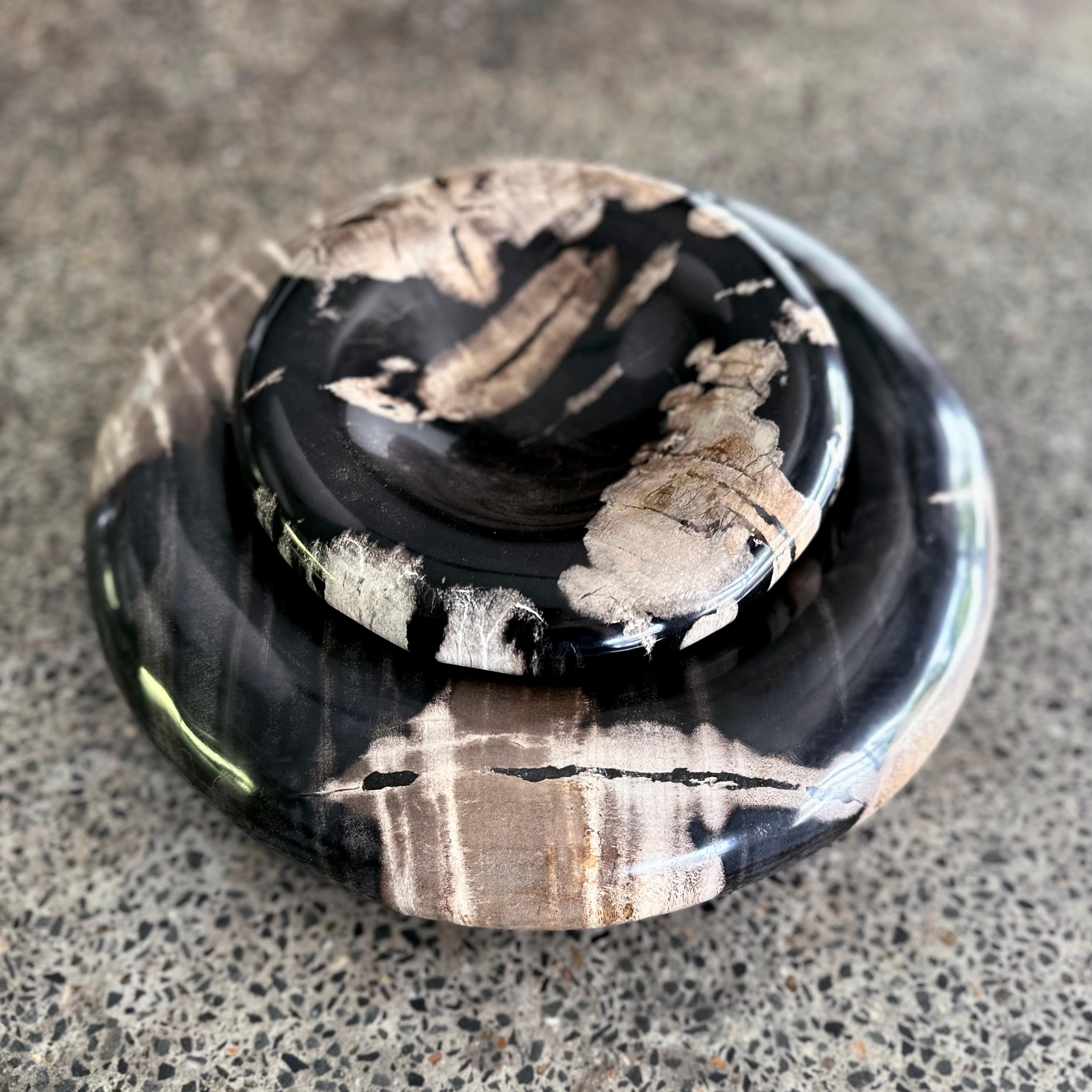 'Round & Round' are modern organic petrified wood sculptural bowls. The striking nature of the mineral motifs featured in this material, compliments the minimalist form. 

This is a meticulously hand sculptured product. Each object will have its own