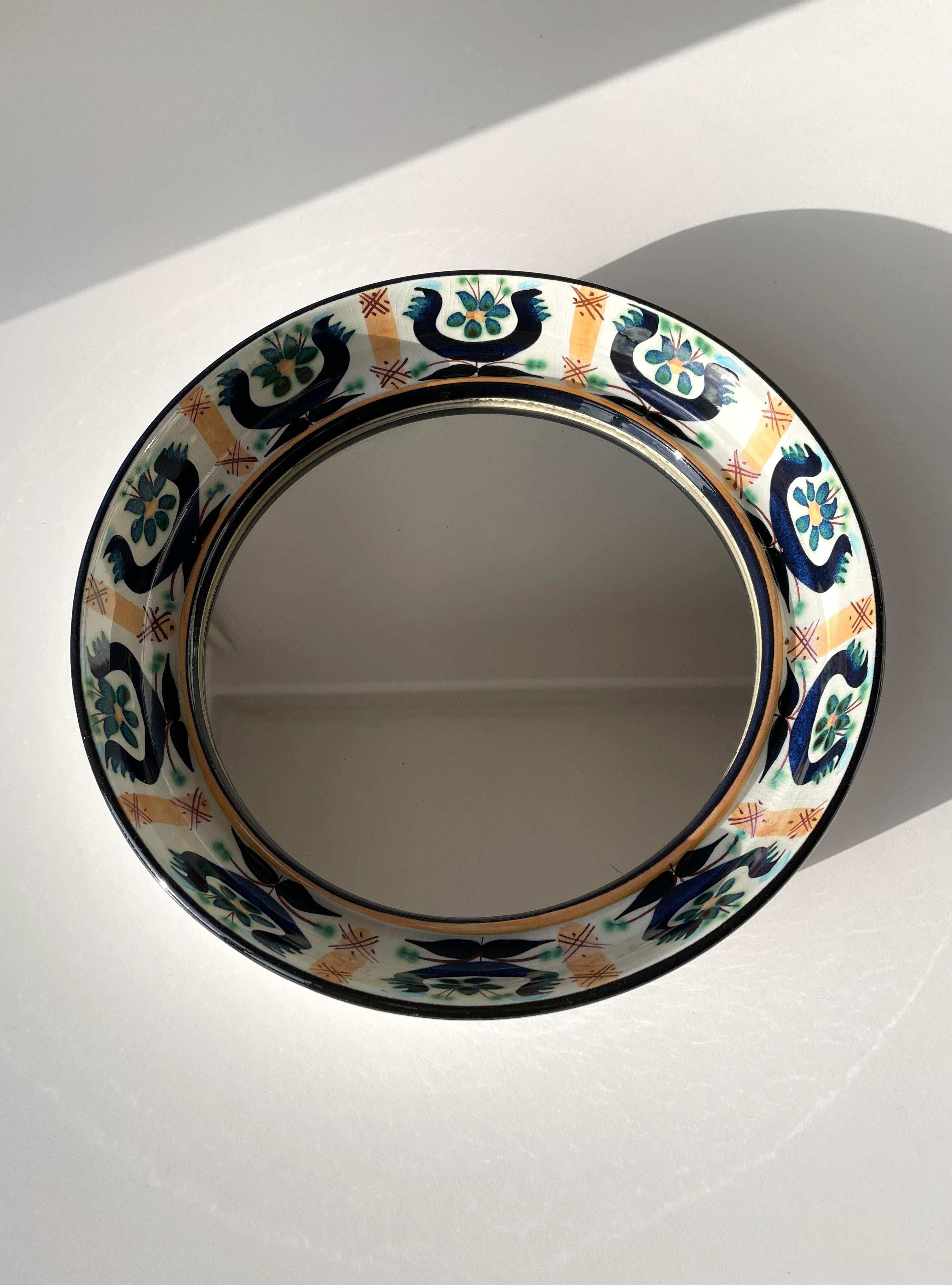 Danish Mid-Century Modern faience frame mirror by Marianne Johanson for the Royal Copenhagen Tenera series. Hand-painted floral organic decor in blue, aqua, green and peach colored glaze on white base. Signed and stamped on top part. Beautiful