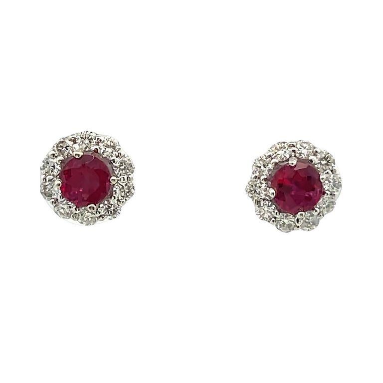 Elevate your style with these exquisite ruby earrings that display elegance and sophistication. Each earring features a high-quality red ruby in the center in 0.77 total carats weight, also a stunning display of luxurious round white diamonds that