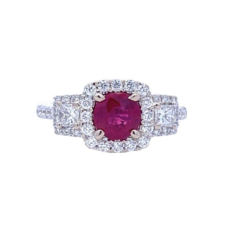 This stunning ring is a beautiful symbol of your love and commitment. Its centerpiece is a GIA-certified red ruby gemstone weighing 1.26 carats and surrounded by two gorgeous white cushion diamonds. The diamonds are further enhanced by surrounding