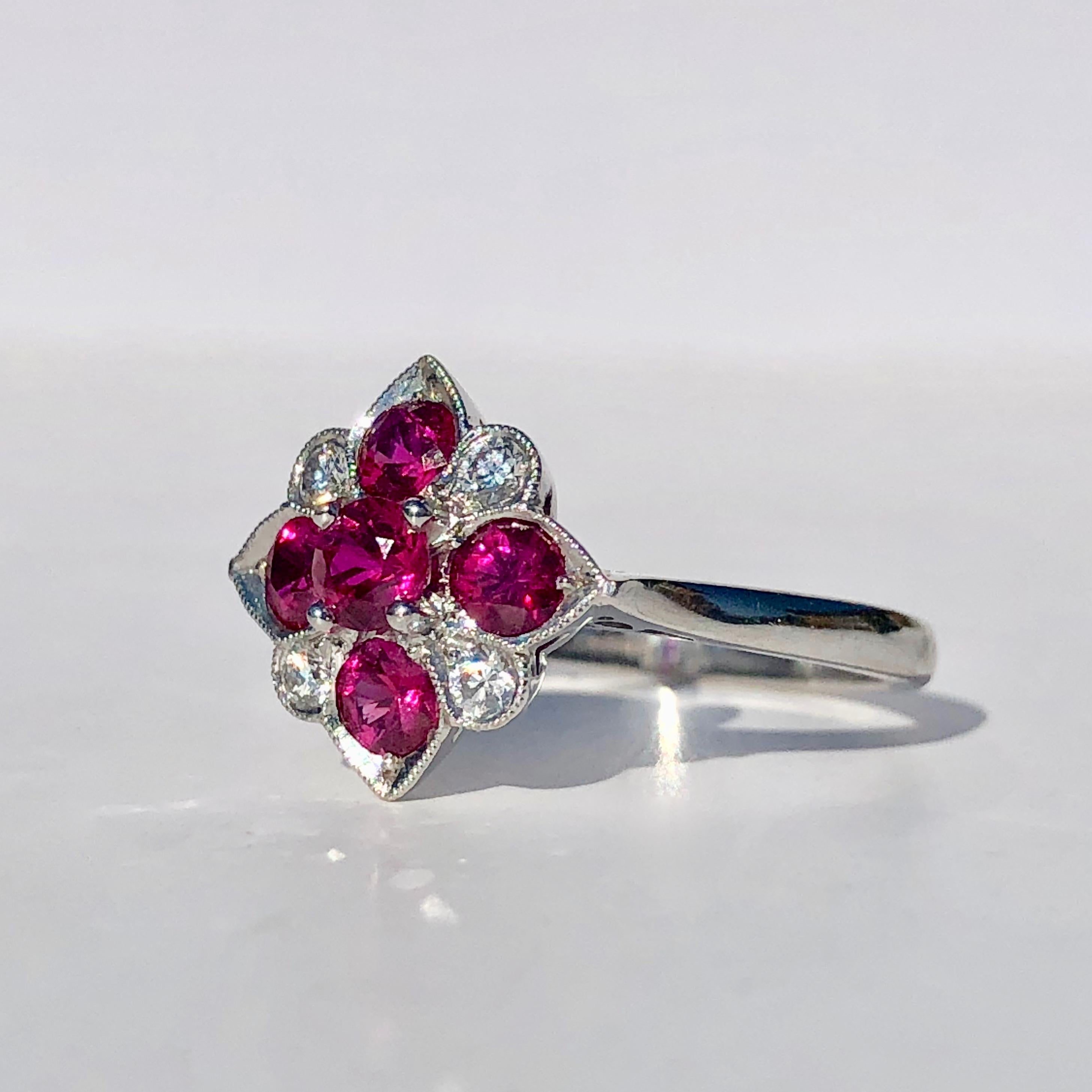 An excellent quality Ruby and Diamond cluster ring

Set with 5 bright round cut Rubies and four round brilliant cut diamonds on 18k white gold 

This ring is a size M1/2 and can be sized up or down by our workshop to fit any finger

12.67mm is the