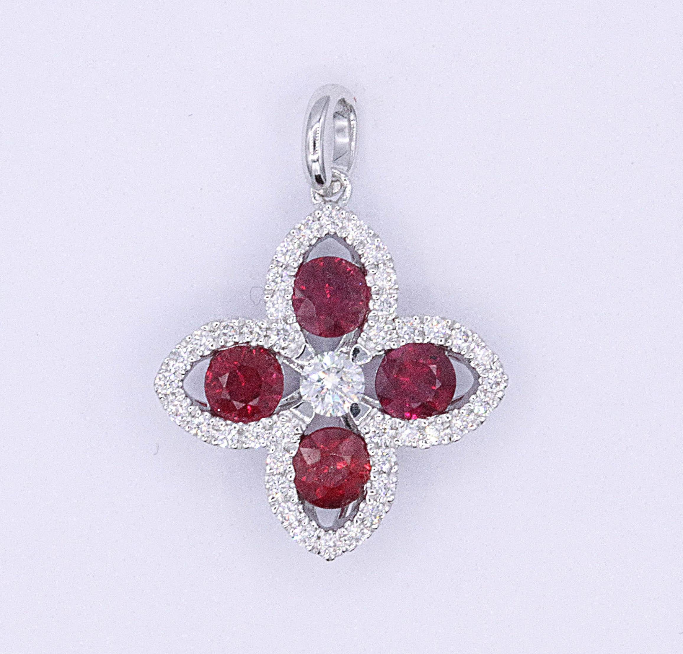 18K White gold pendant featuring four red rubies weighing 0.84 carats flanked with 41 round diamonds weighing 0.24 carats. Color H-I Clarity SI