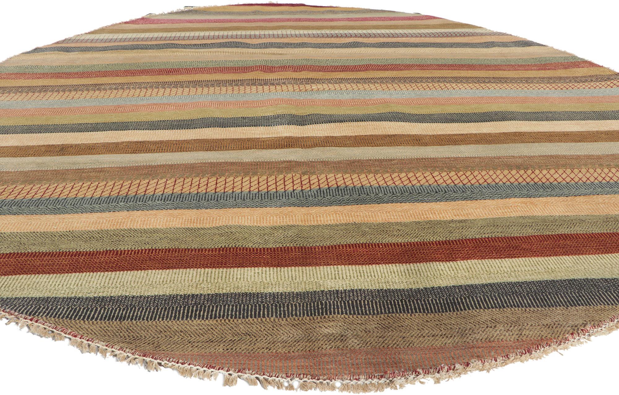 30300 New Contemporary Round Striped Area Rug 08'11 x 09'00.
This hand-knotted wool new contemporary round area rug features a striped pattern composed of both wide and narrow bands spread across the abrashed field. The overall design aesthetic is