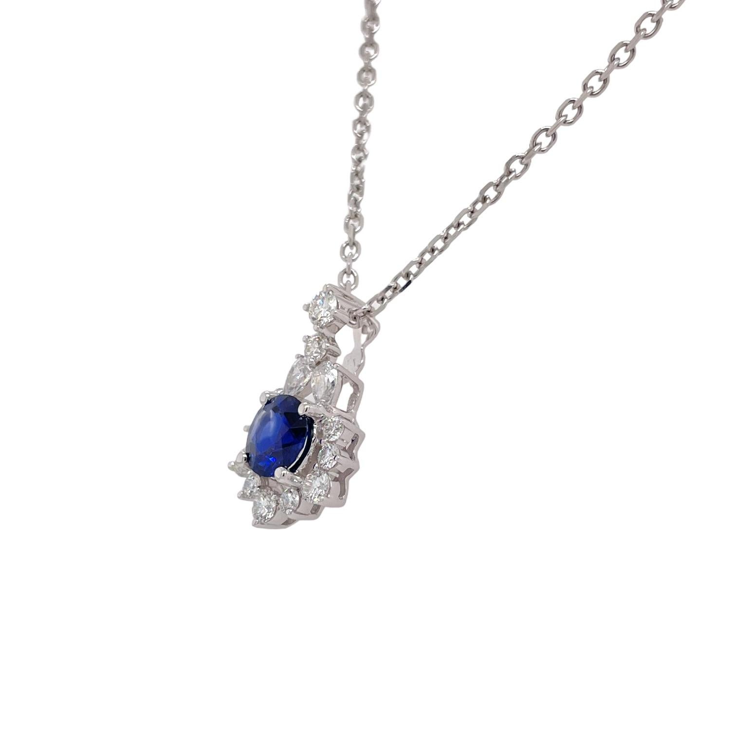 Pendant contains 1 center round brilliant sapphire, 0.85ct and round brilliant & pear shape diamonds surrounding, 0.56tcw. Diamonds are near colorless and SI1 in clarity. Pendant hangs from a 16