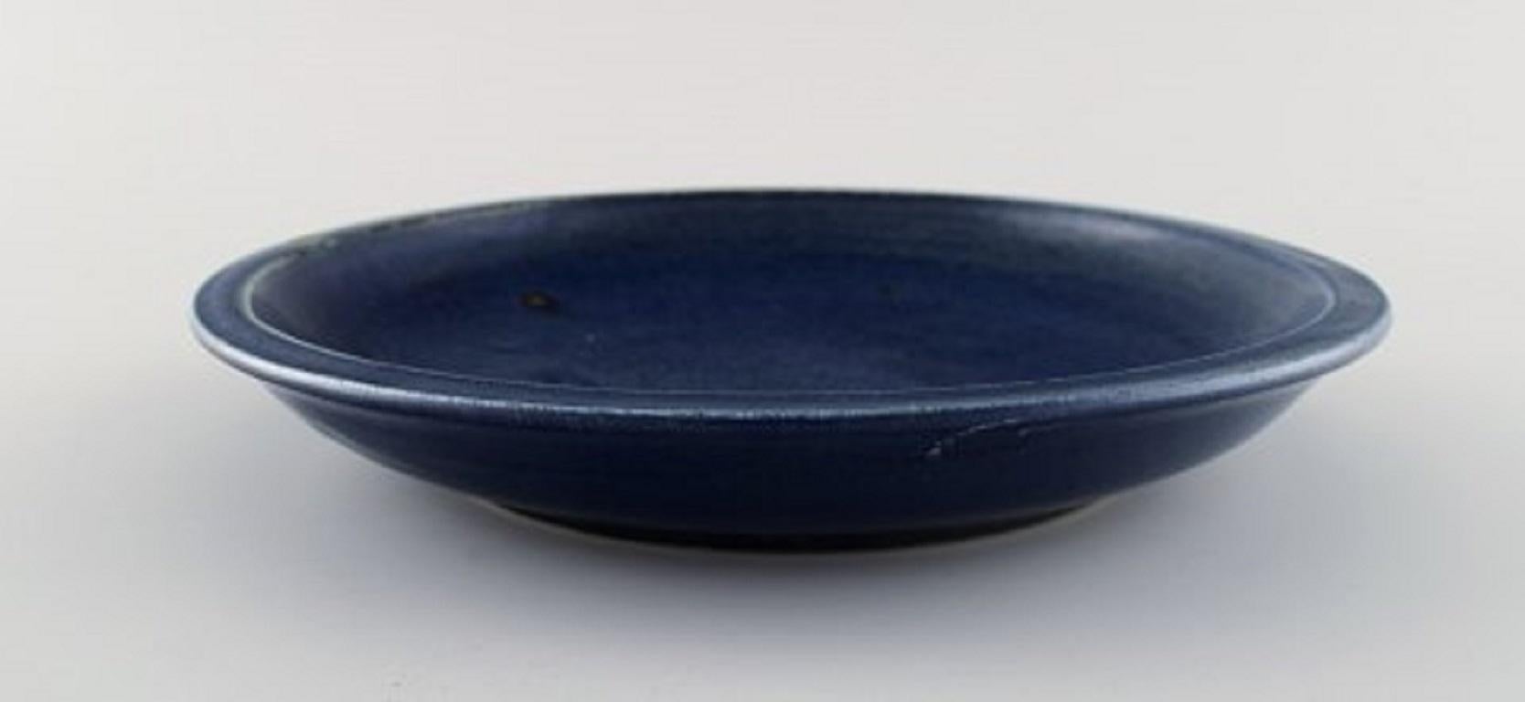 Round Saxbo dish in glazed stoneware. Beautiful glaze in deep blue shades.
Measures: 24 x 4 cm.
Stamped.
In very good condition with a few minor glaze defects from production.
 